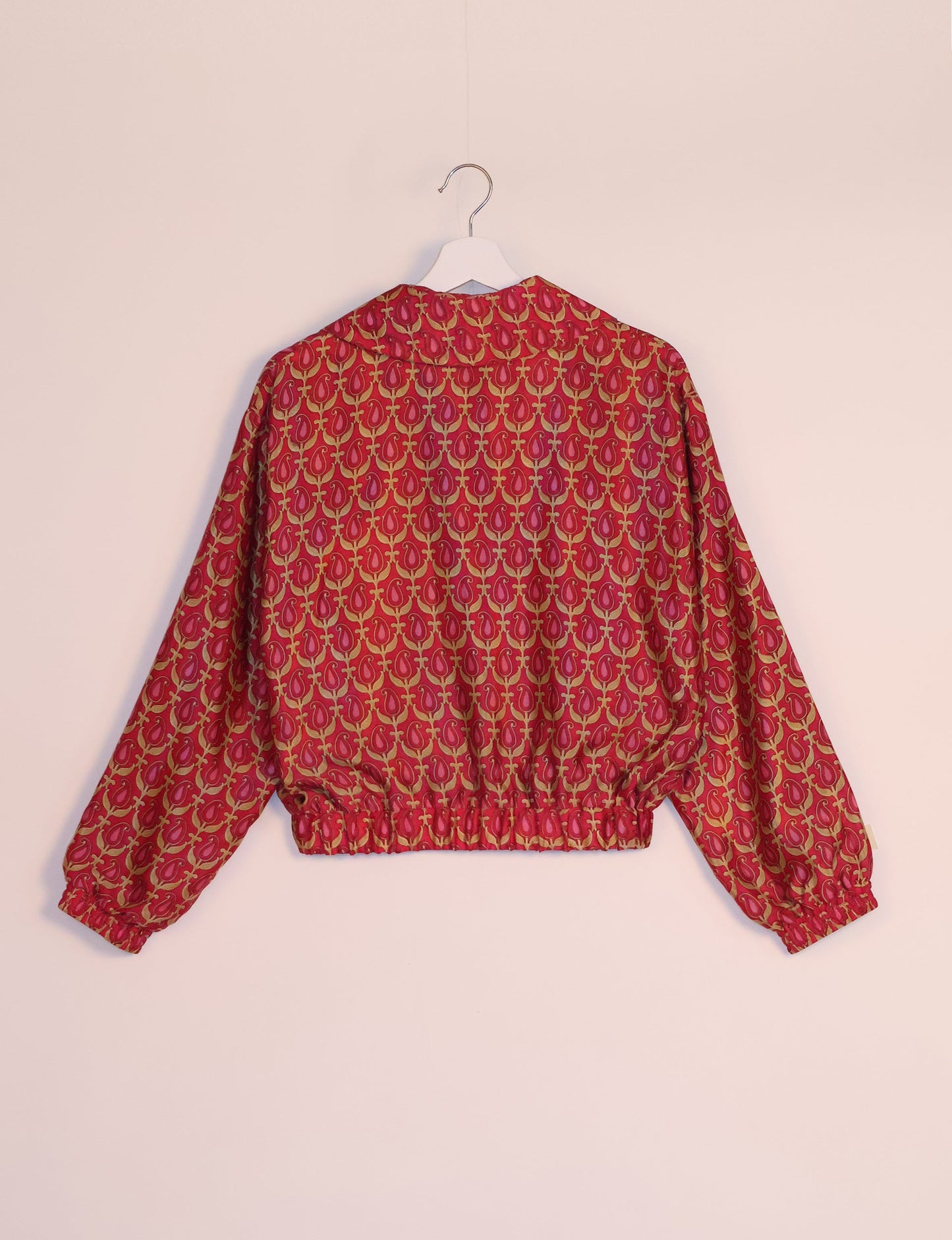 Stylish BOMBER JACKET, an upcycled clothing masterpiece with a cute cropped shape, elasticated details, and detachable metallic zipper. Contrast sari print lining adds a unique touch. Explore sustainable and eco-friendly fashion.