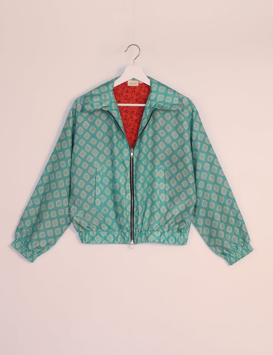 Stylish BOMBER JACKET, an upcycled clothing masterpiece with a cute cropped shape, elasticated details, and detachable metallic zipper. Contrast sari print lining adds a unique touch. Explore sustainable and eco-friendly fashion.