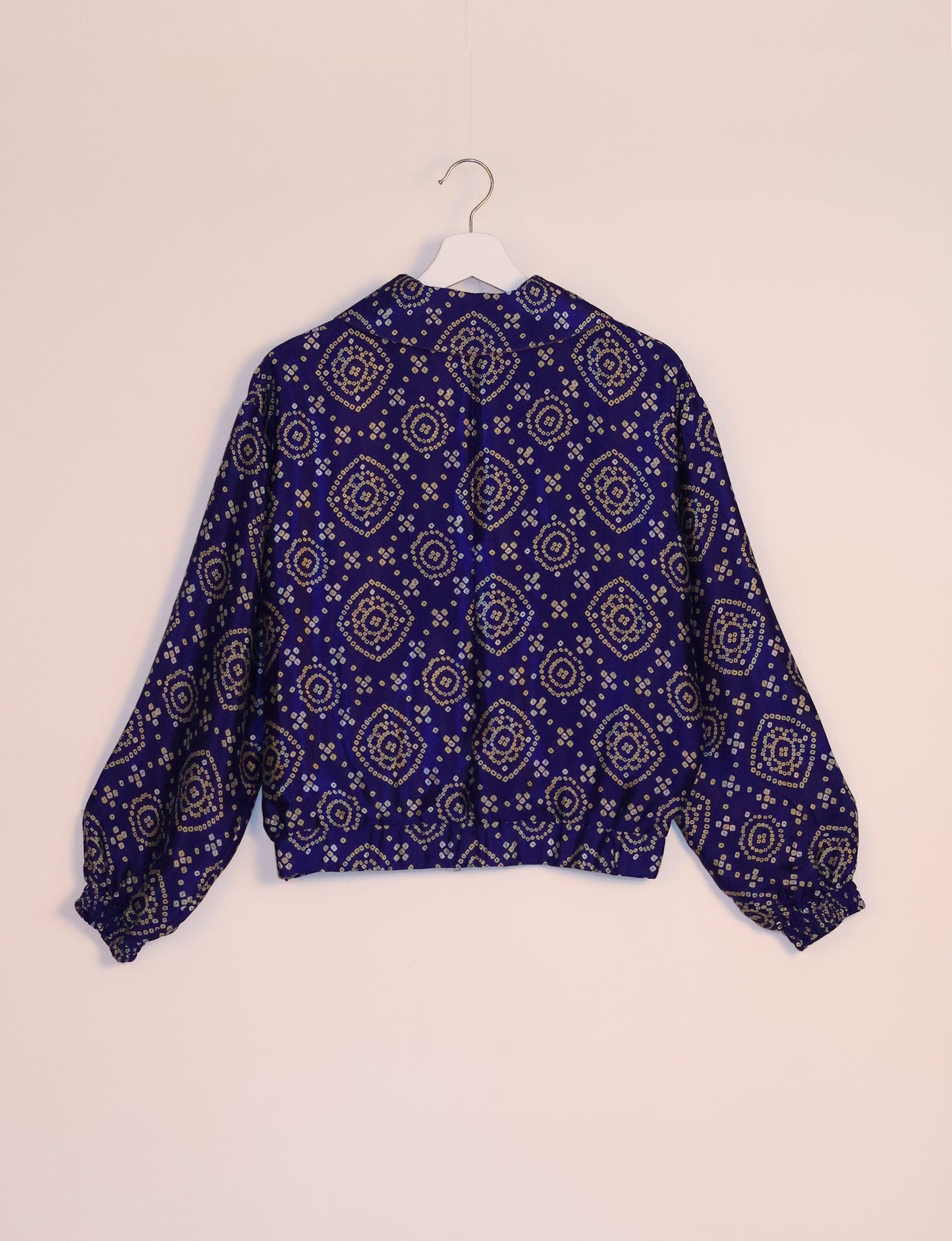 Stylish BOMBER JACKET, an upcycled clothing masterpiece with a cute cropped shape, elasticated details, and detachable metallic zipper. Contrast sari print lining adds a unique touch. Explore sustainable and eco-friendly fashion.