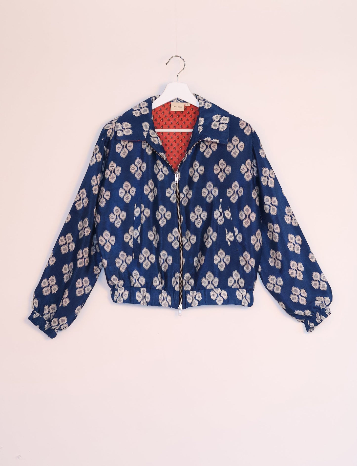 Stylish BOMBER JACKET, an upcycled clothing masterpiece with a cute cropped shape, elasticated details, and detachable metallic zipper. Contrast sari print lining adds a unique touch. Explore sustainable and eco-friendly fashion.