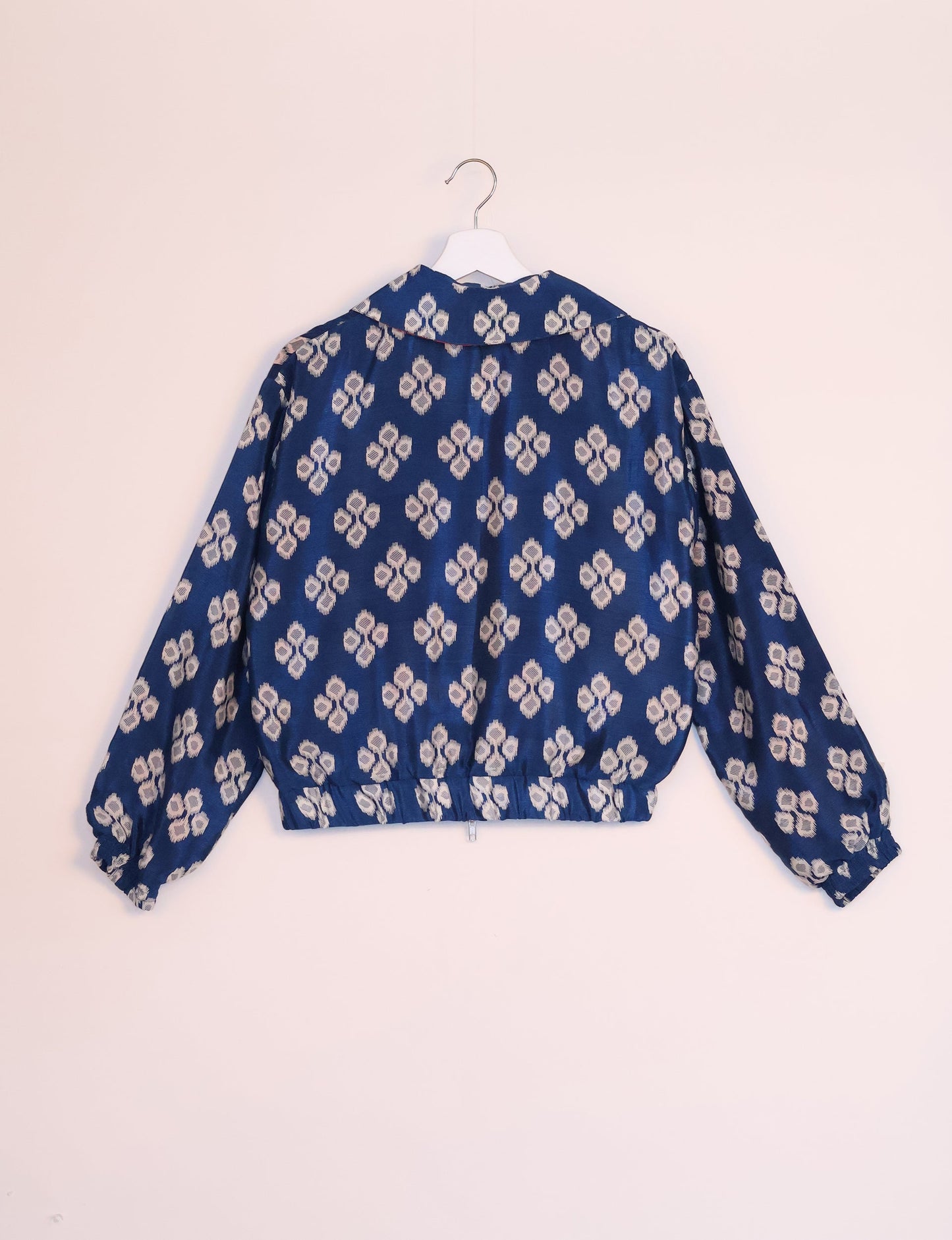 Stylish BOMBER JACKET, an upcycled clothing masterpiece with a cute cropped shape, elasticated details, and detachable metallic zipper. Contrast sari print lining adds a unique touch. Explore sustainable and eco-friendly fashion.