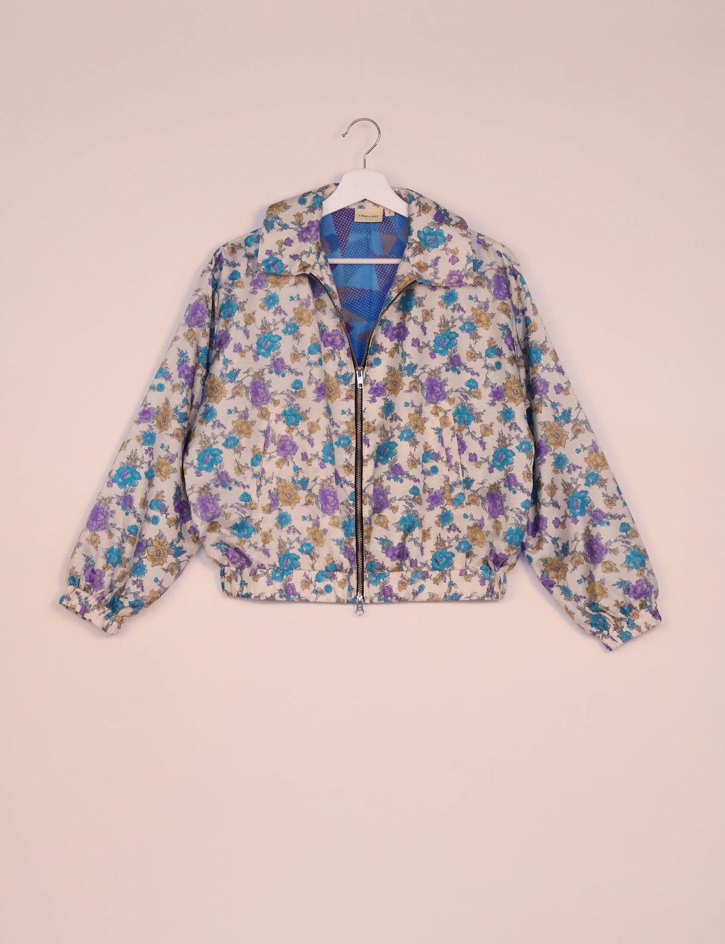 Stylish BOMBER JACKET, an upcycled clothing masterpiece with a cute cropped shape, elasticated details, and detachable metallic zipper. Contrast sari print lining adds a unique touch. Explore sustainable and eco-friendly fashion.