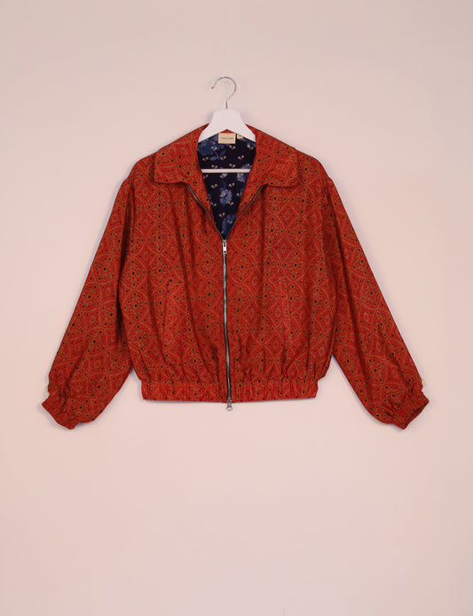 Stylish BOMBER JACKET, an upcycled clothing masterpiece with a cute cropped shape, elasticated details, and detachable metallic zipper. Contrast sari print lining adds a unique touch. Explore sustainable and eco-friendly fashion.