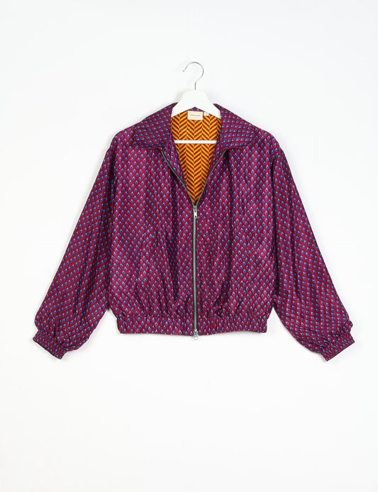 Stylish BOMBER JACKET, an upcycled clothing masterpiece with a cute cropped shape, elasticated details, and detachable metallic zipper. Contrast sari print lining adds a unique touch. Explore sustainable and eco-friendly fashion.