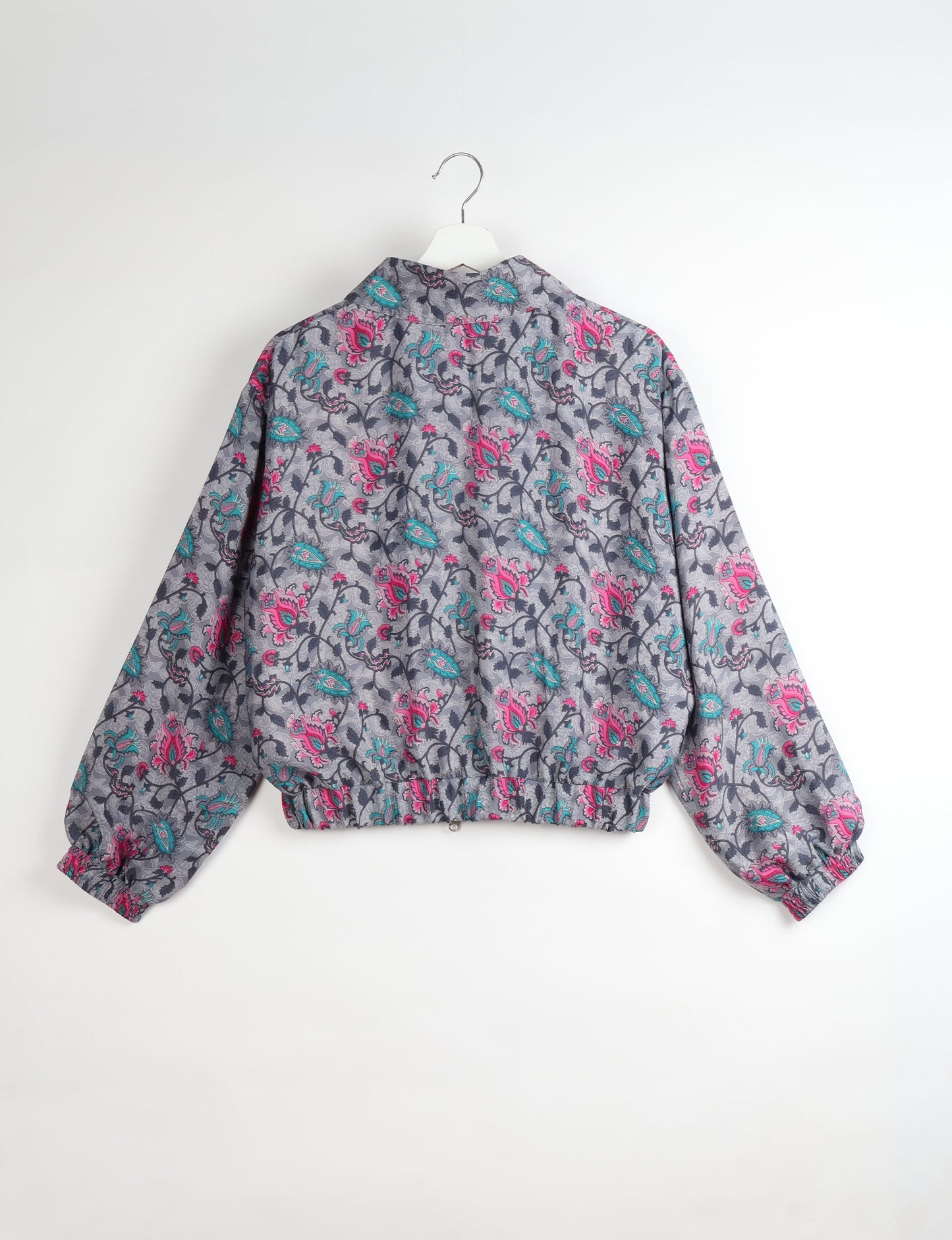 Upcycled Bomber Jacket made from recycled sari materials, featuring a cute cropped shape, elasticated hem and cuffs, and contrast sari print lining. Sustainable apparel promoting eco-friendly fashion and ethical clothing.