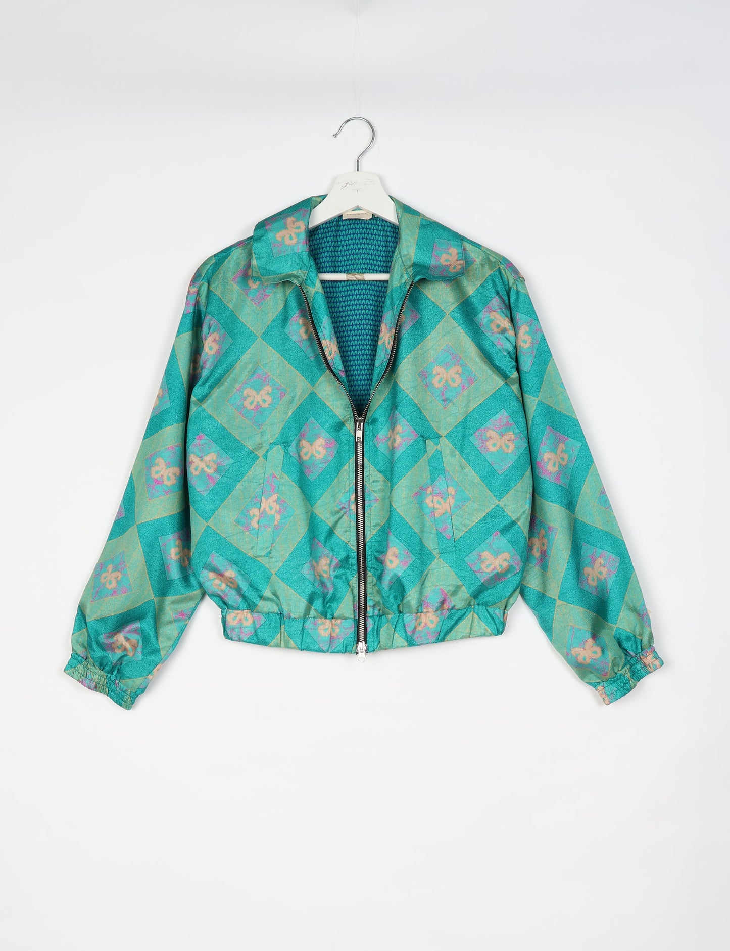 Upcycled Bomber Jacket made from recycled sari materials, featuring a cute cropped shape, elasticated hem and cuffs, and contrast sari print lining. Sustainable apparel promoting eco-friendly fashion and ethical clothing.