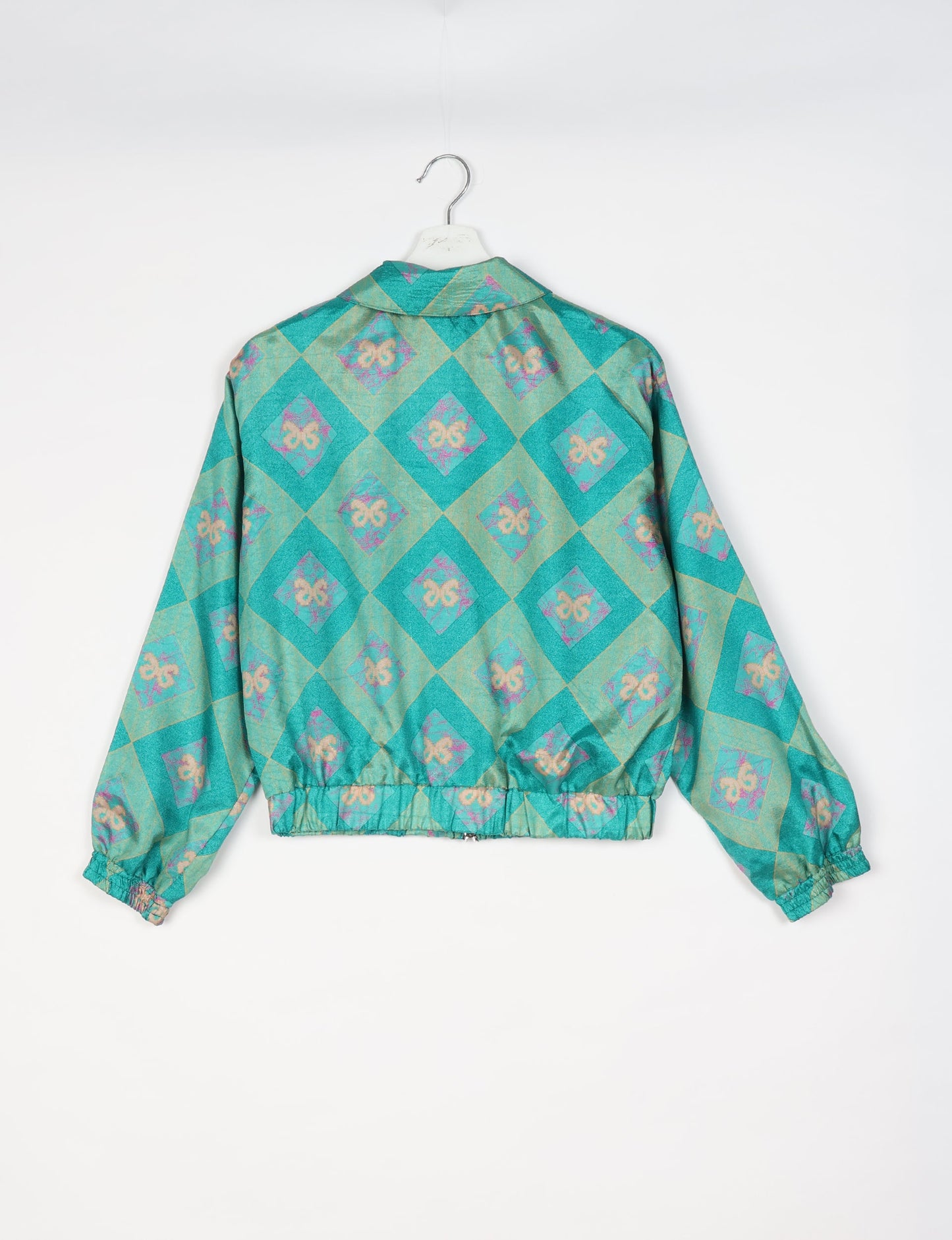 Upcycled Bomber Jacket made from recycled sari materials, featuring a cute cropped shape, elasticated hem and cuffs, and contrast sari print lining. Sustainable apparel promoting eco-friendly fashion and ethical clothing.