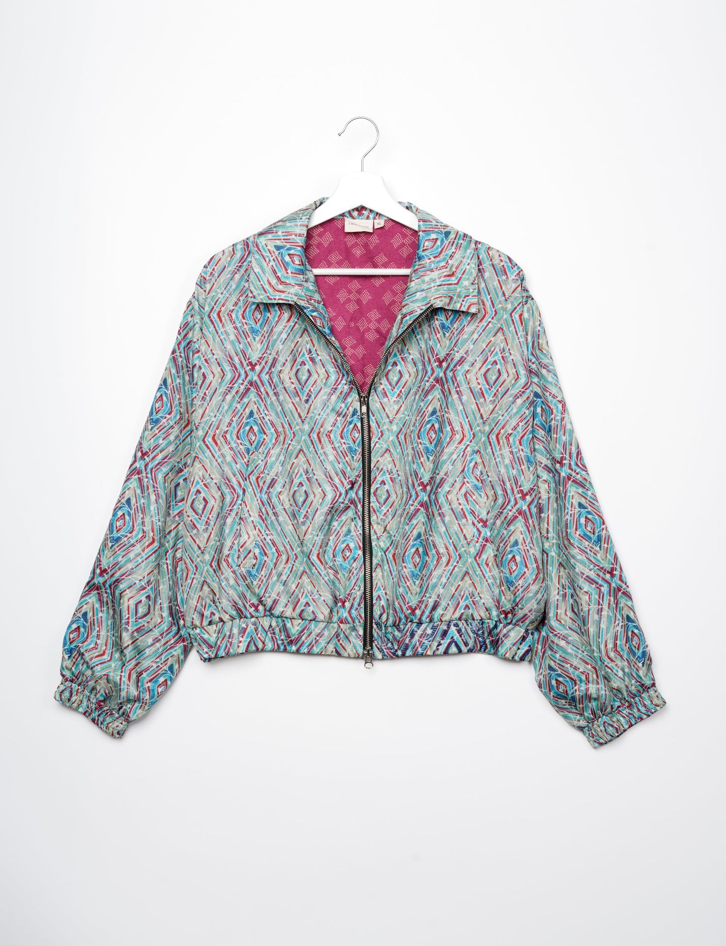 Stylish BOMBER JACKET, an upcycled clothing masterpiece with a cute cropped shape, elasticated details, and detachable metallic zipper. Contrast sari print lining adds a unique touch. Explore sustainable and eco-friendly fashion.