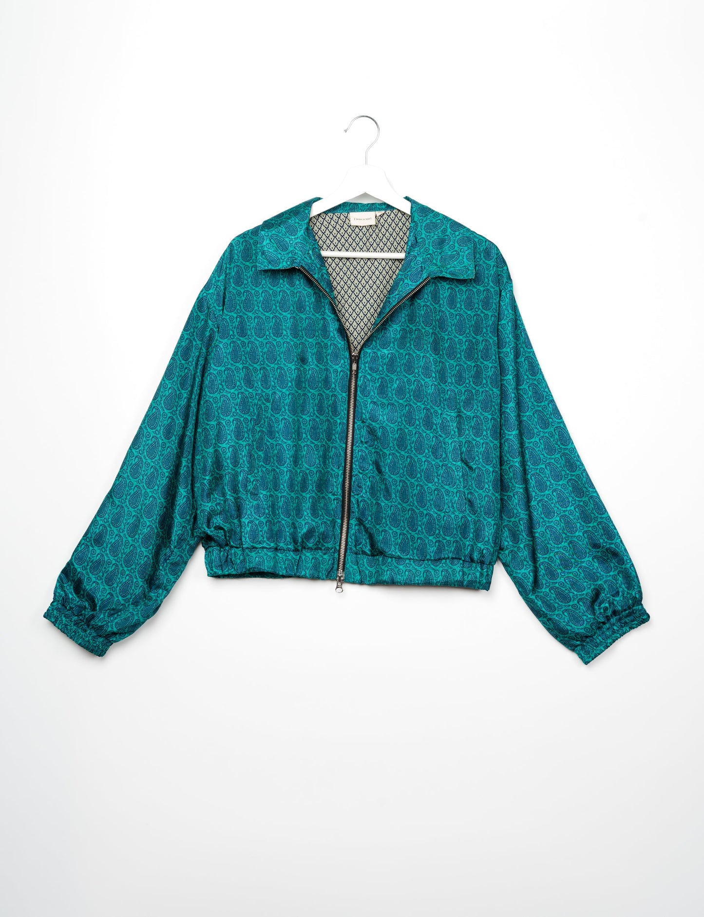 Stylish BOMBER JACKET, an upcycled clothing masterpiece with a cute cropped shape, elasticated details, and detachable metallic zipper. Contrast sari print lining adds a unique touch. Explore sustainable and eco-friendly fashion.