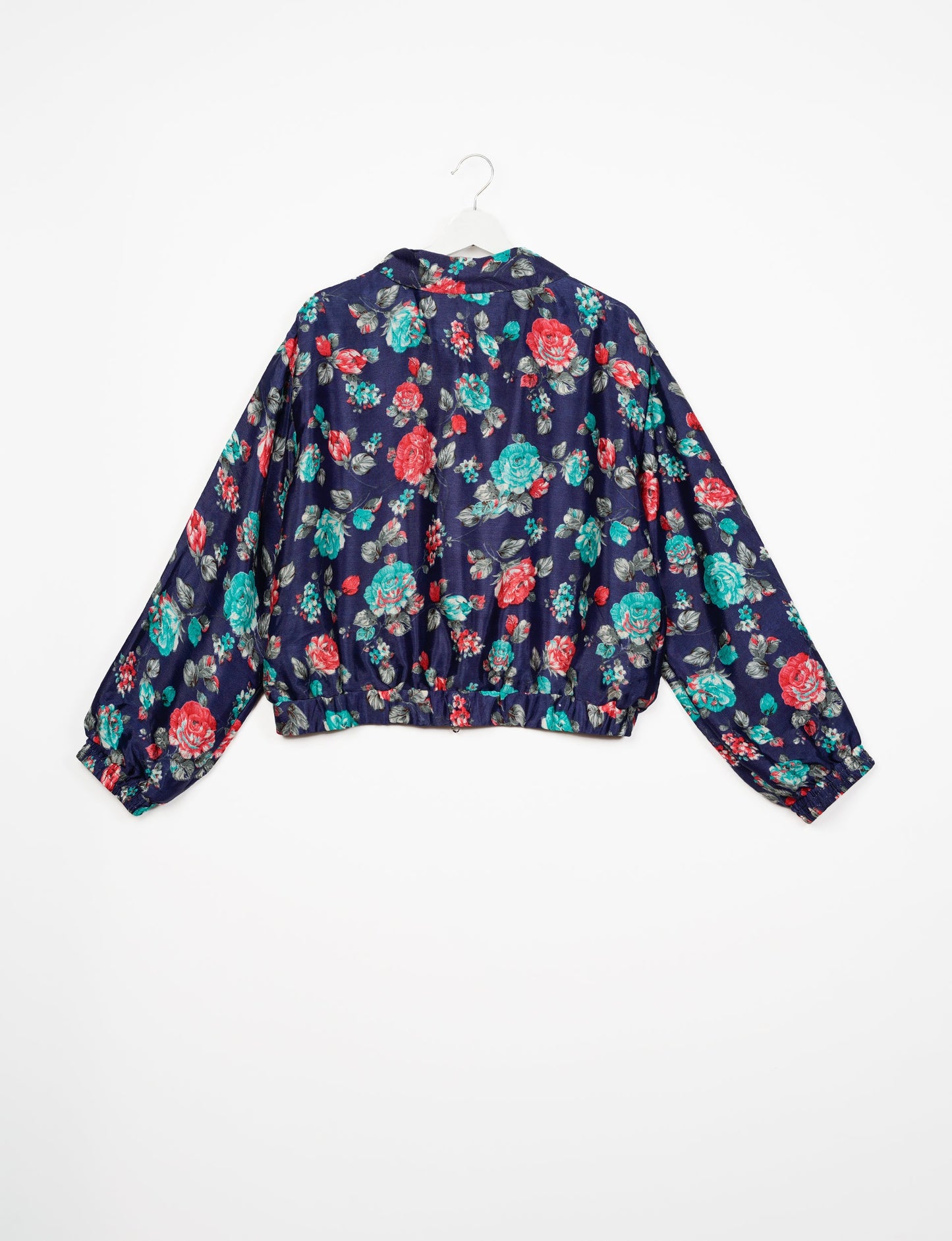 Stylish BOMBER JACKET, an upcycled clothing masterpiece with a cute cropped shape, elasticated details, and detachable metallic zipper. Contrast sari print lining adds a unique touch. Explore sustainable and eco-friendly fashion.