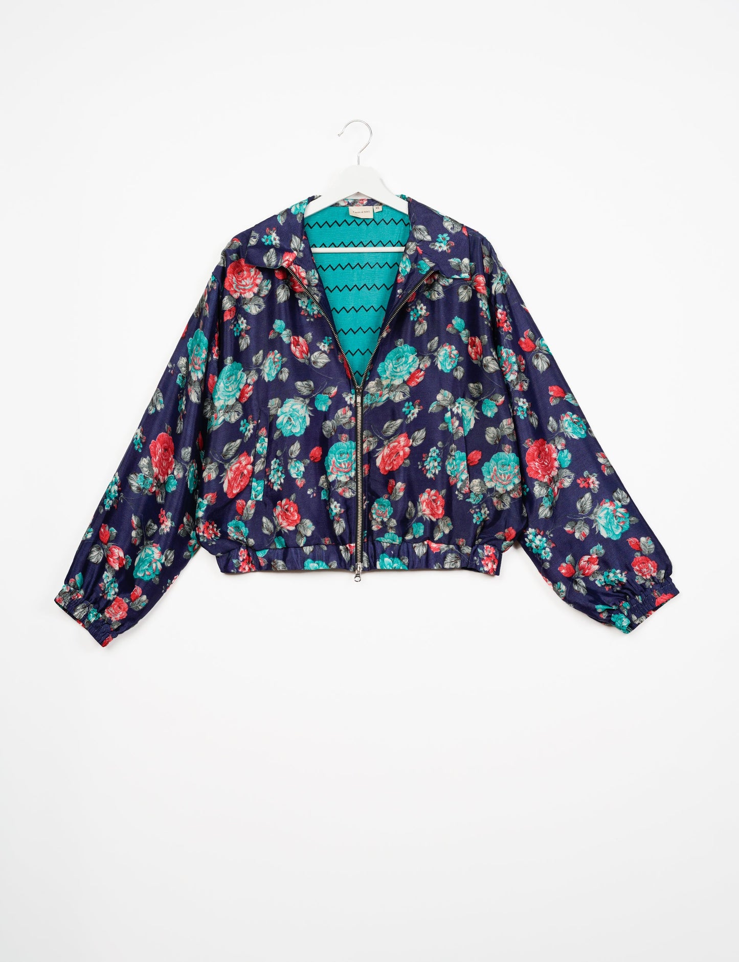 Stylish BOMBER JACKET, an upcycled clothing masterpiece with a cute cropped shape, elasticated details, and detachable metallic zipper. Contrast sari print lining adds a unique touch. Explore sustainable and eco-friendly fashion.