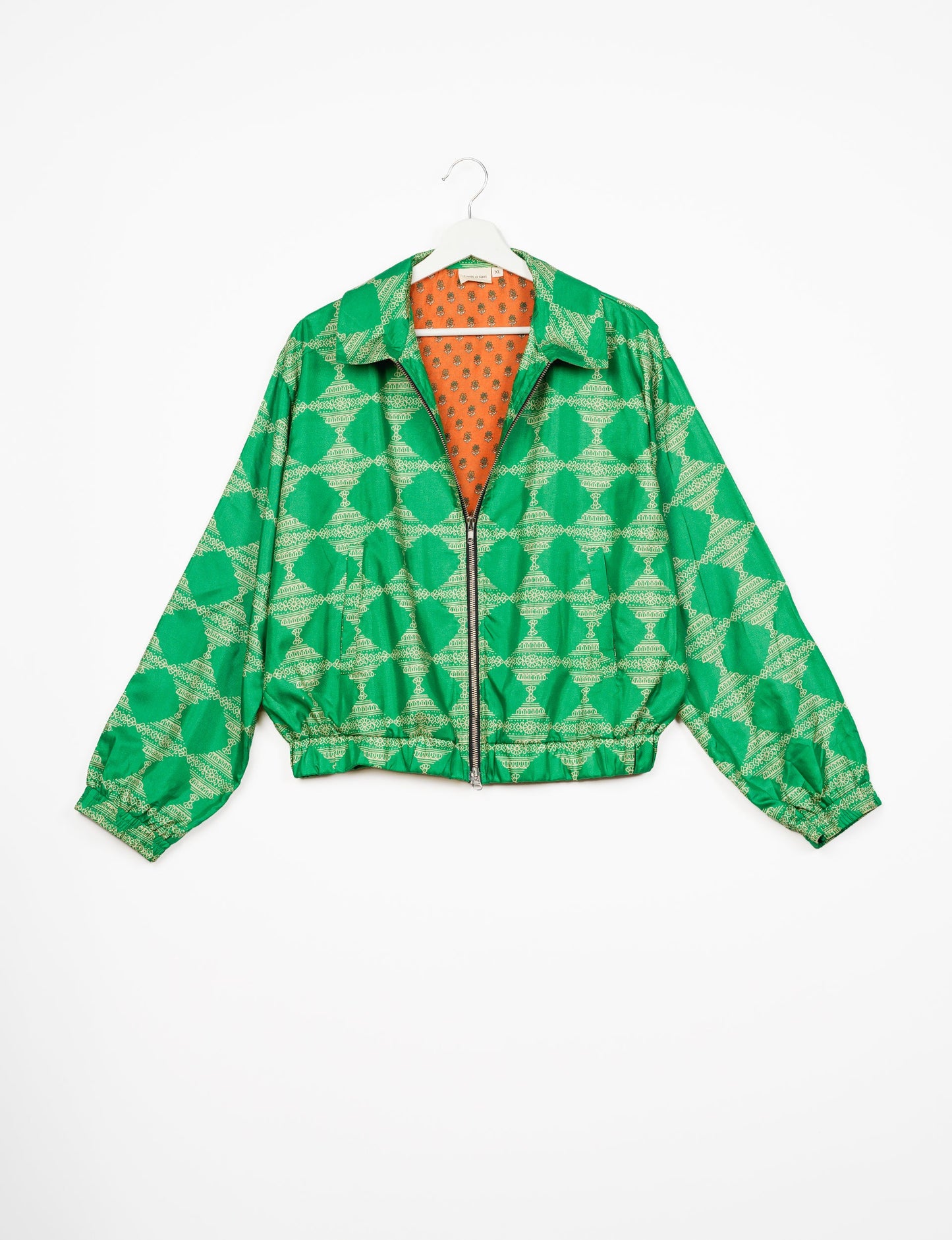 Stylish BOMBER JACKET, an upcycled clothing masterpiece with a cute cropped shape, elasticated details, and detachable metallic zipper. Contrast sari print lining adds a unique touch. Explore sustainable and eco-friendly fashion.