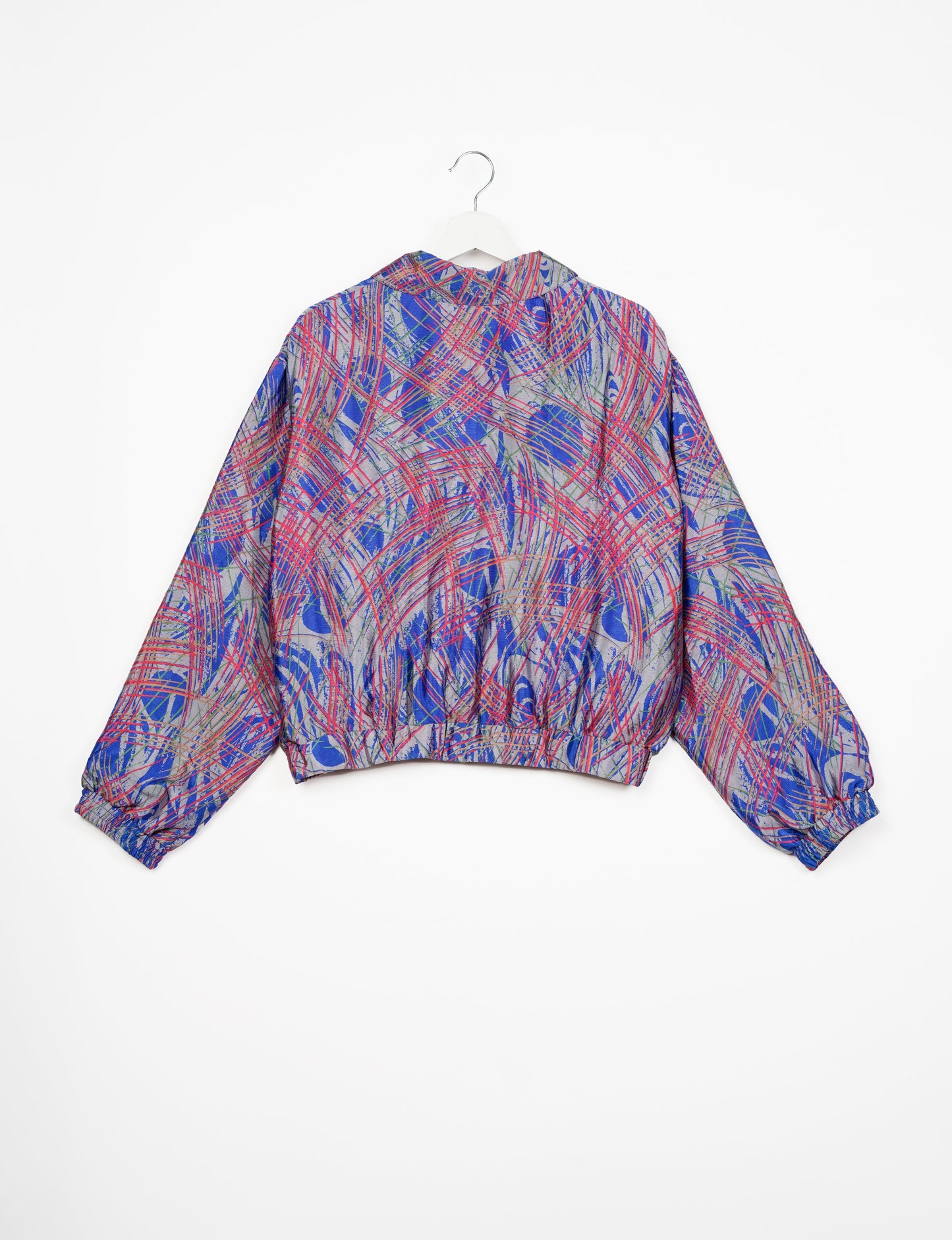 Stylish BOMBER JACKET, an upcycled clothing masterpiece with a cute cropped shape, elasticated details, and detachable metallic zipper. Contrast sari print lining adds a unique touch. Explore sustainable and eco-friendly fashion.