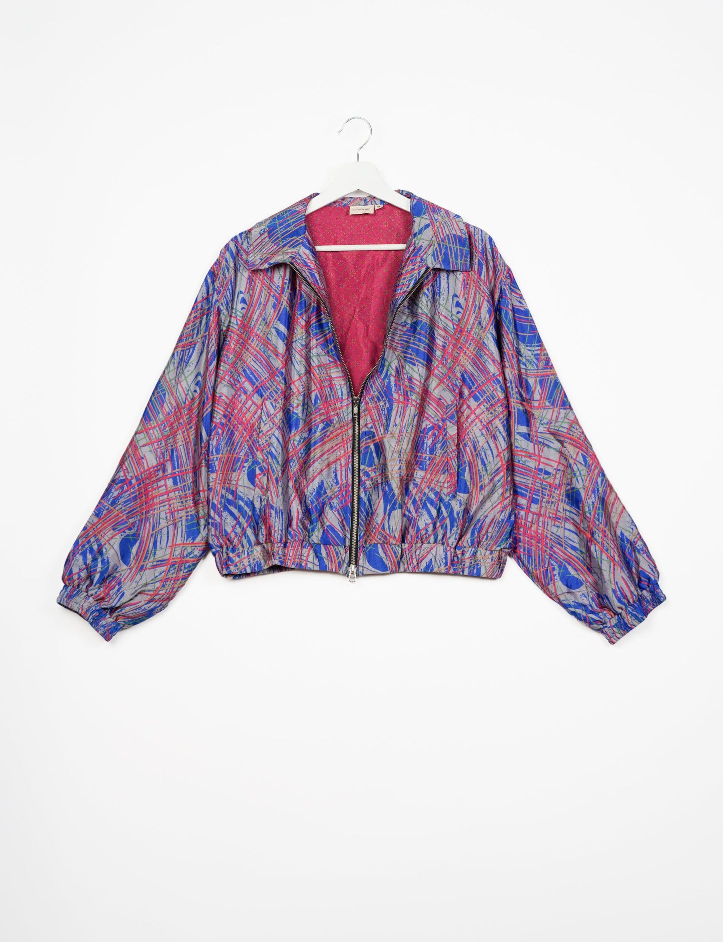 Stylish BOMBER JACKET, an upcycled clothing masterpiece with a cute cropped shape, elasticated details, and detachable metallic zipper. Contrast sari print lining adds a unique touch. Explore sustainable and eco-friendly fashion.