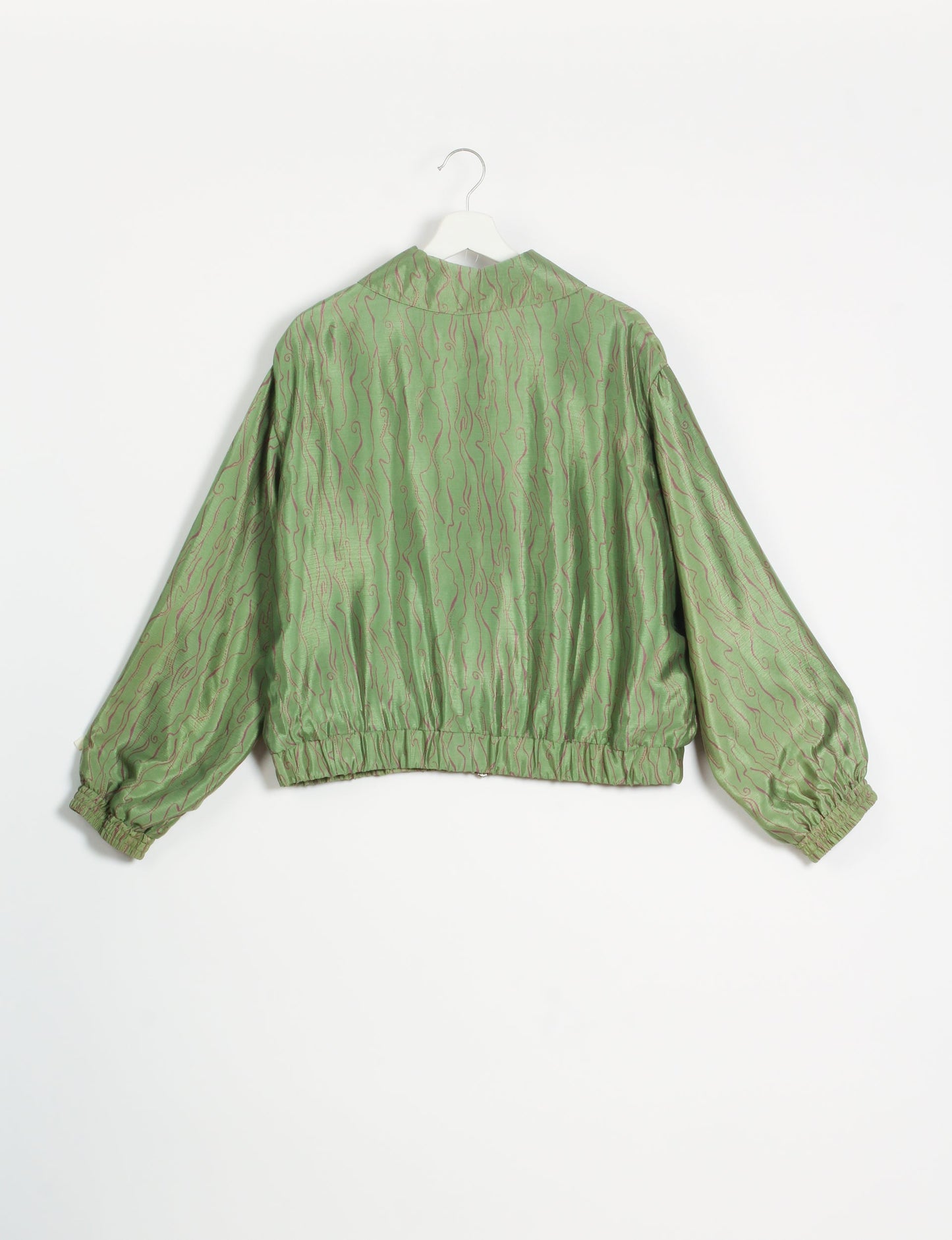 Stylish BOMBER JACKET, an upcycled clothing masterpiece with a cute cropped shape, elasticated details, and detachable metallic zipper. Contrast sari print lining adds a unique touch. Explore sustainable and eco-friendly fashion.