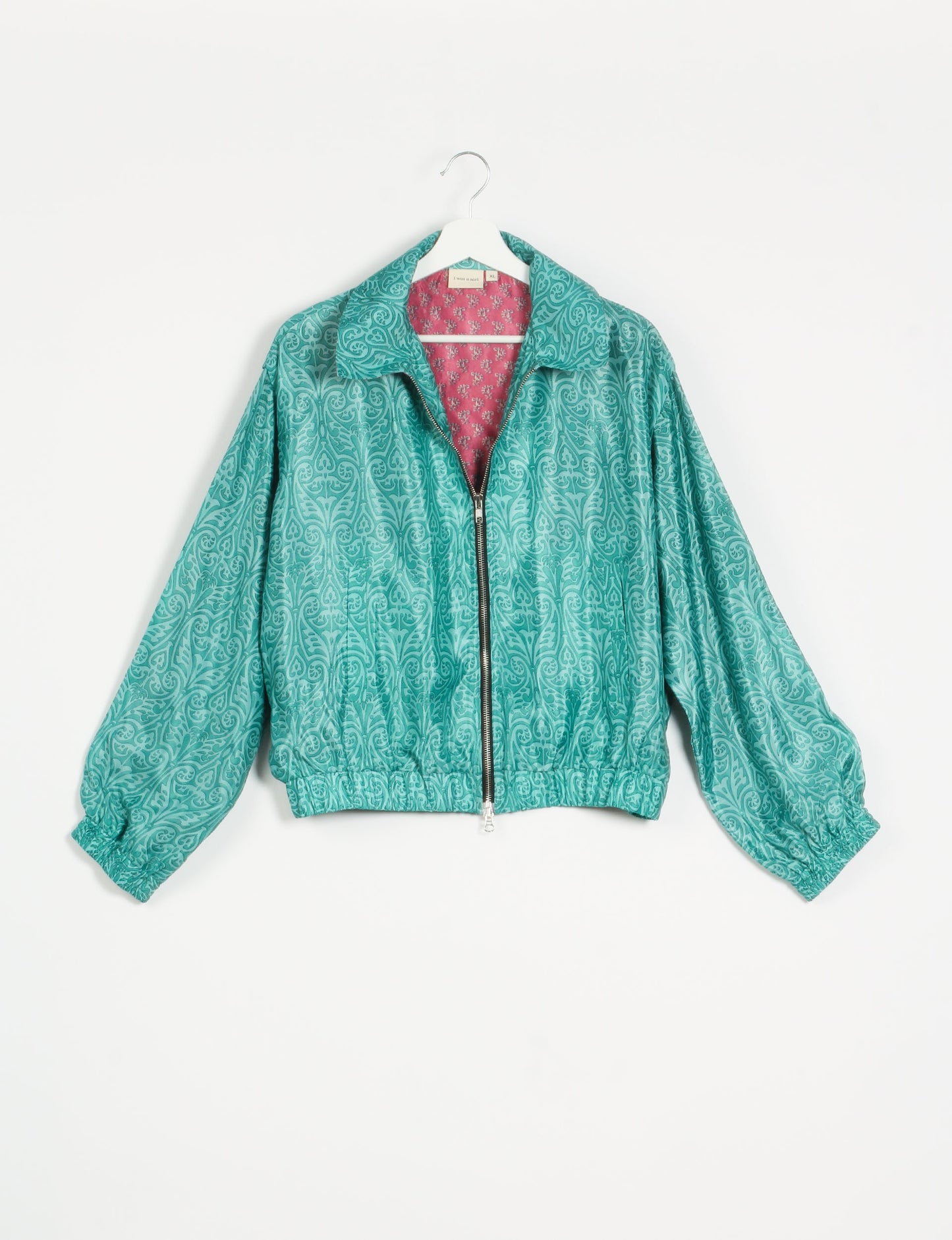 Stylish BOMBER JACKET, an upcycled clothing masterpiece with a cute cropped shape, elasticated details, and detachable metallic zipper. Contrast sari print lining adds a unique touch. Explore sustainable and eco-friendly fashion.