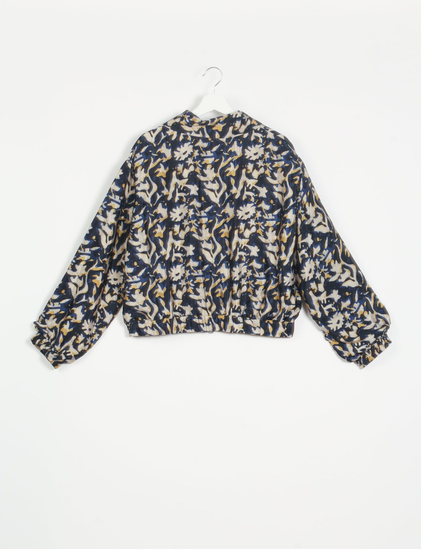 Stylish BOMBER JACKET, an upcycled clothing masterpiece with a cute cropped shape, elasticated details, and detachable metallic zipper. Contrast sari print lining adds a unique touch. Explore sustainable and eco-friendly fashion.