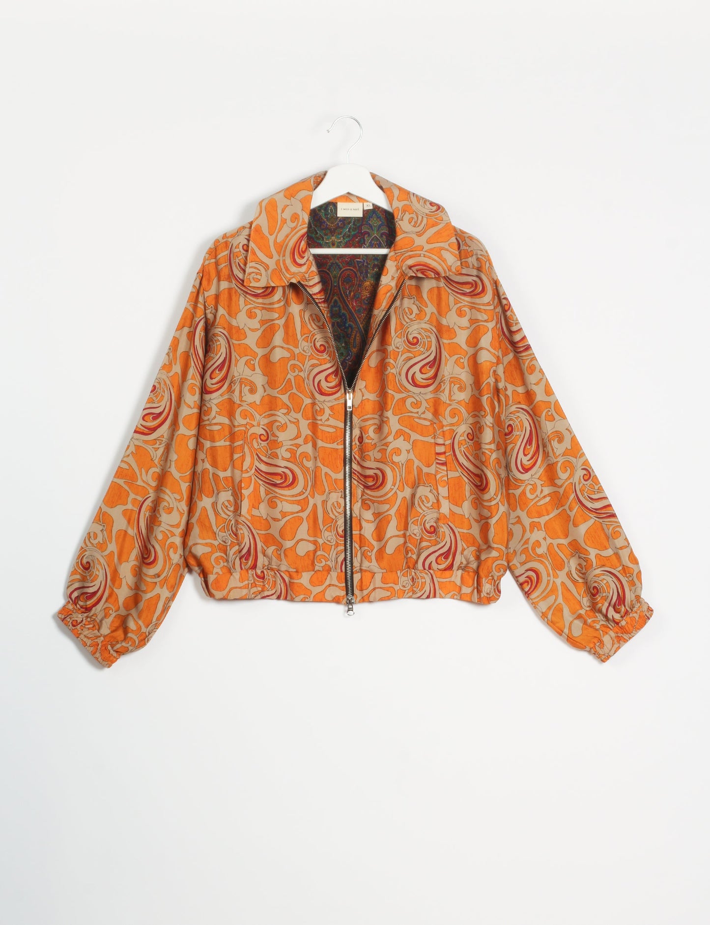 Stylish BOMBER JACKET, an upcycled clothing masterpiece with a cute cropped shape, elasticated details, and detachable metallic zipper. Contrast sari print lining adds a unique touch. Explore sustainable and eco-friendly fashion.