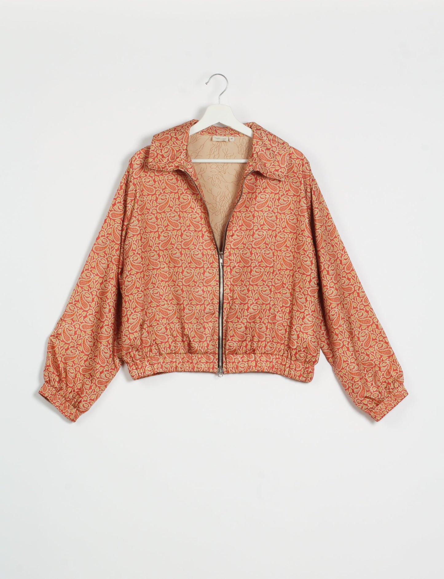 Stylish BOMBER JACKET, an upcycled clothing masterpiece with a cute cropped shape, elasticated details, and detachable metallic zipper. Contrast sari print lining adds a unique touch. Explore sustainable and eco-friendly fashion.