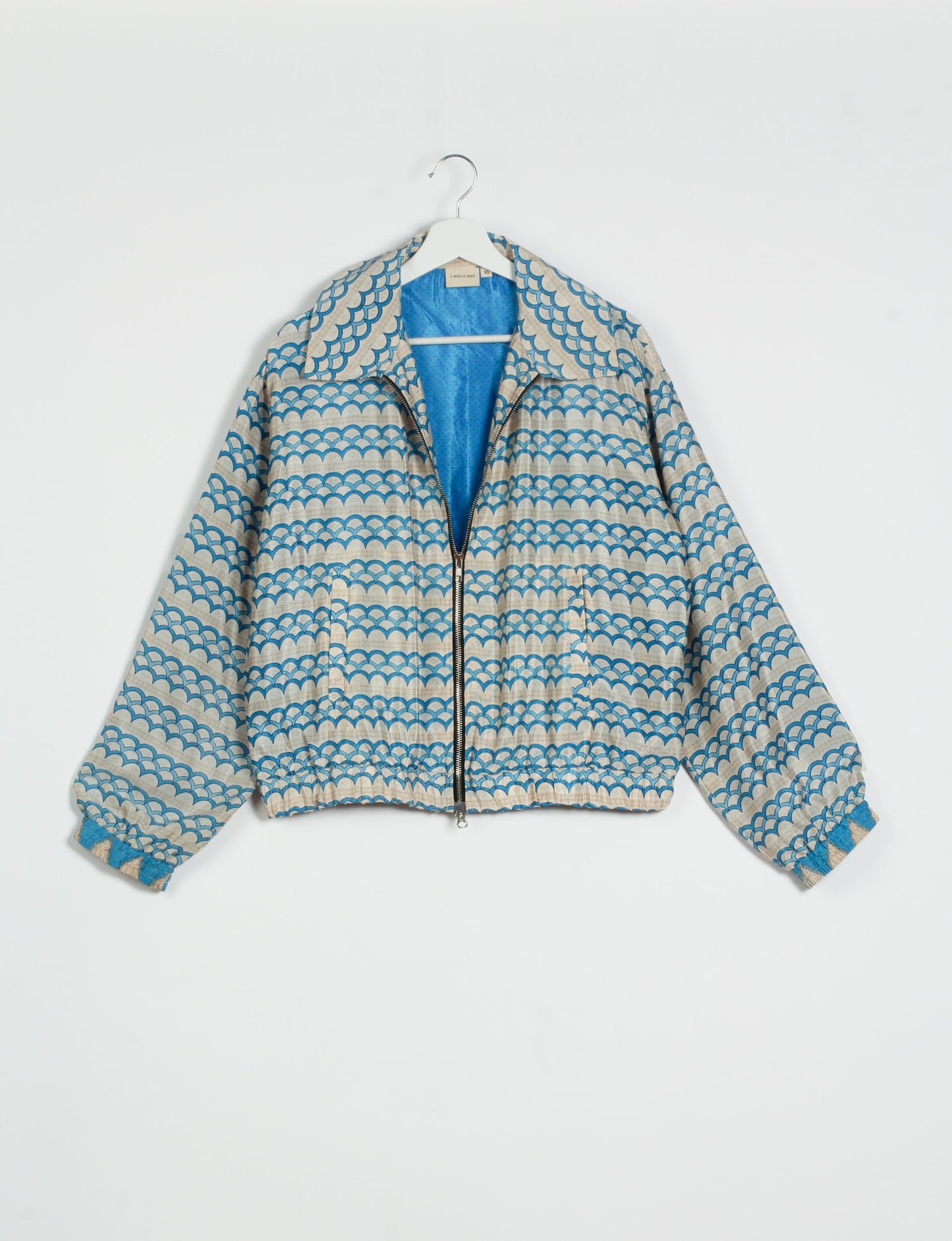 Stylish BOMBER JACKET, an upcycled clothing masterpiece with a cute cropped shape, elasticated details, and detachable metallic zipper. Contrast sari print lining adds a unique touch. Explore sustainable and eco-friendly fashion.