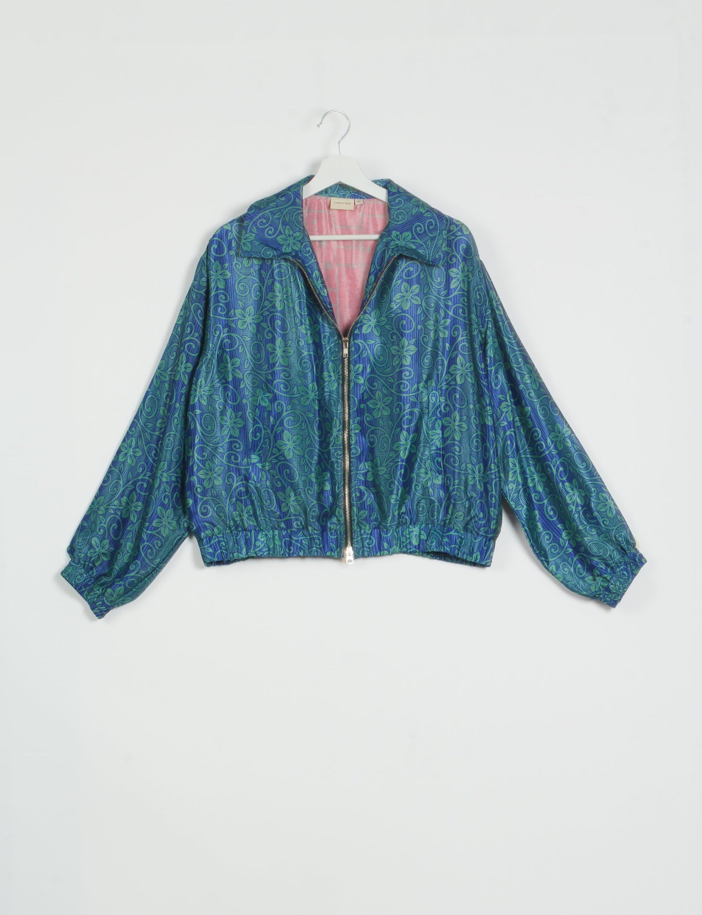 Stylish BOMBER JACKET, an upcycled clothing masterpiece with a cute cropped shape, elasticated details, and detachable metallic zipper. Contrast sari print lining adds a unique touch. Explore sustainable and eco-friendly fashion.