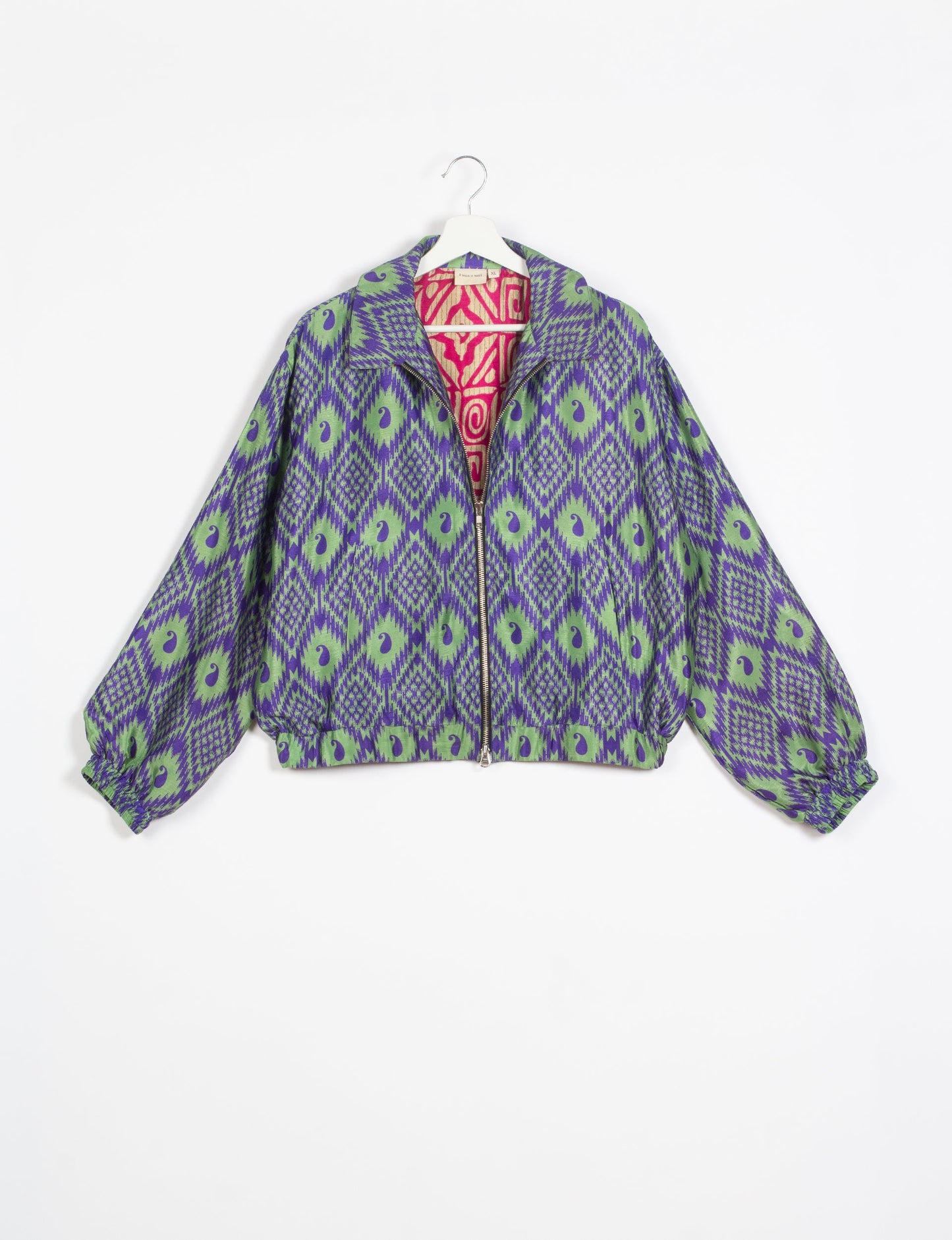 Stylish BOMBER JACKET, an upcycled clothing masterpiece with a cute cropped shape, elasticated details, and detachable metallic zipper. Contrast sari print lining adds a unique touch. Explore sustainable and eco-friendly fashion.