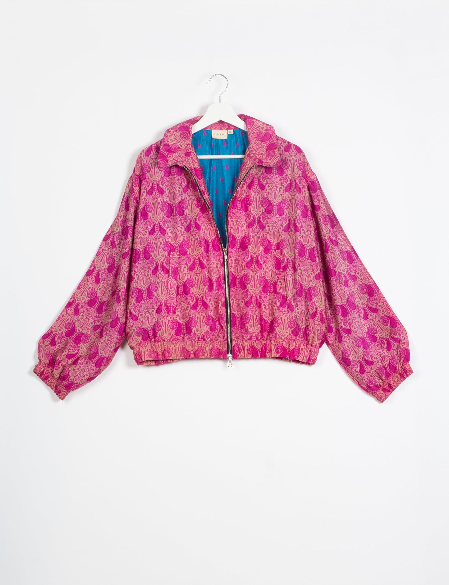 Stylish BOMBER JACKET, an upcycled clothing masterpiece with a cute cropped shape, elasticated details, and detachable metallic zipper. Contrast sari print lining adds a unique touch. Explore sustainable and eco-friendly fashion.