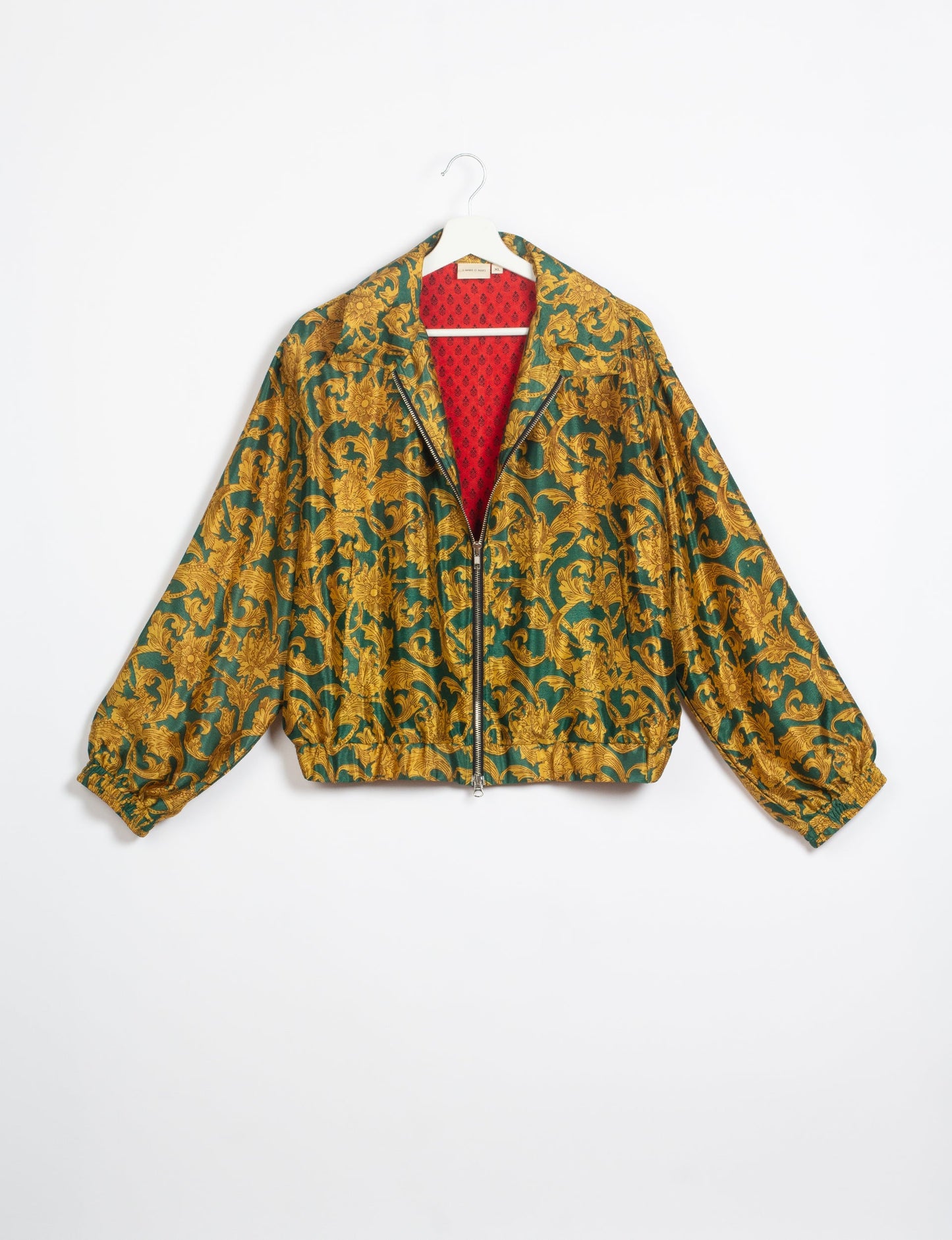 Stylish BOMBER JACKET, an upcycled clothing masterpiece with a cute cropped shape, elasticated details, and detachable metallic zipper. Contrast sari print lining adds a unique touch. Explore sustainable and eco-friendly fashion.