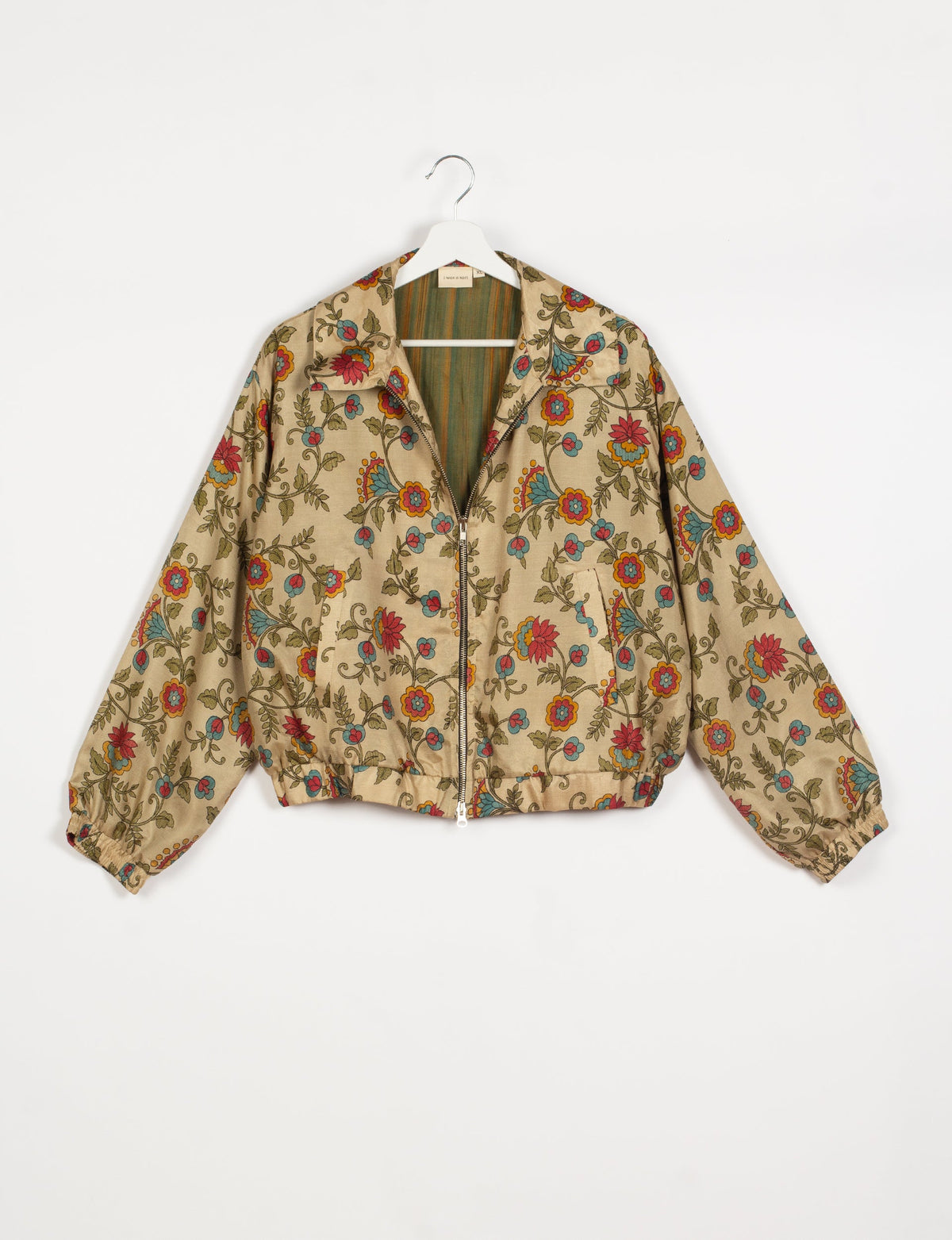 Stylish BOMBER JACKET, an upcycled clothing masterpiece with a cute cropped shape, elasticated details, and detachable metallic zipper. Contrast sari print lining adds a unique touch. Explore sustainable and eco-friendly fashion.