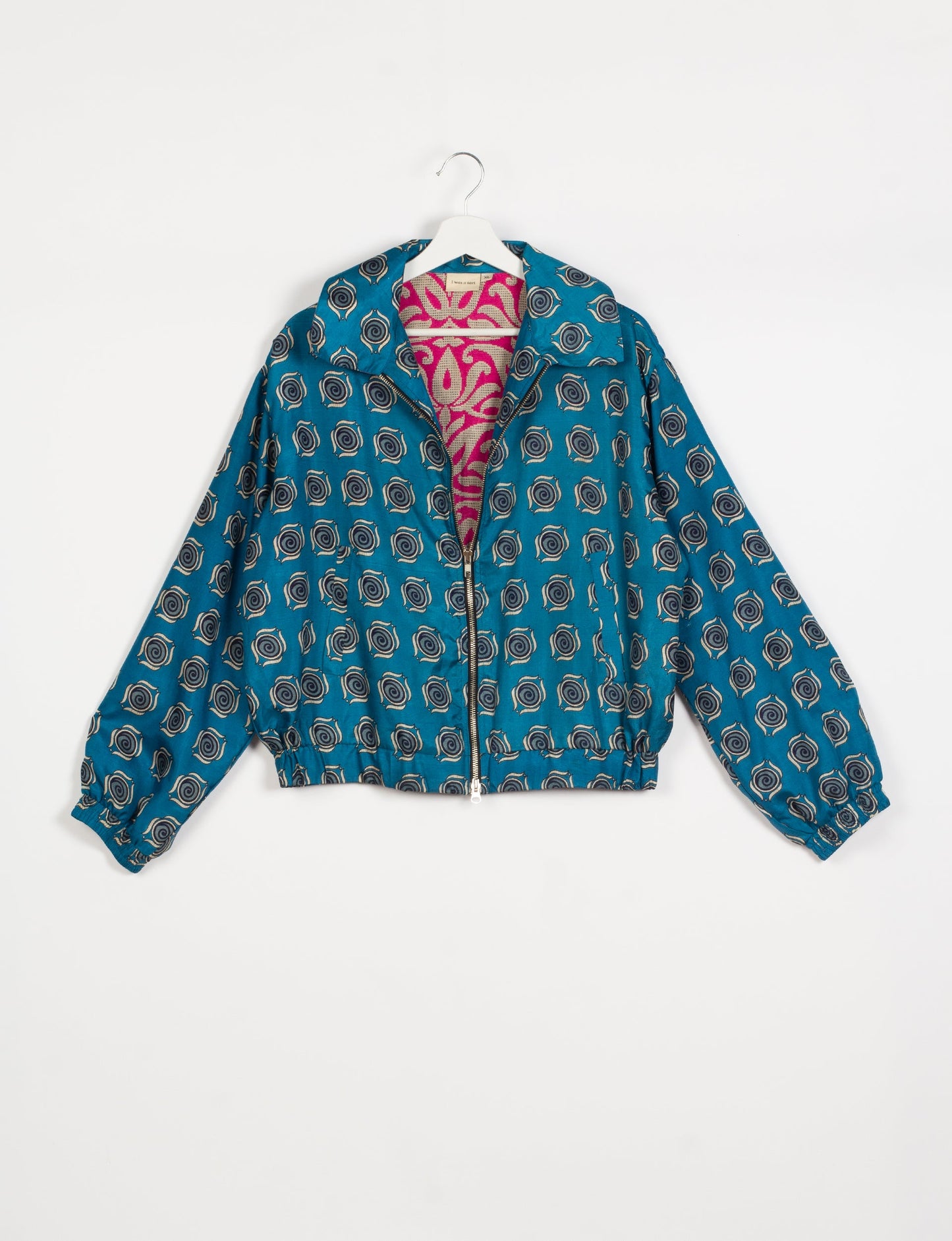 Stylish BOMBER JACKET, an upcycled clothing masterpiece with a cute cropped shape, elasticated details, and detachable metallic zipper. Contrast sari print lining adds a unique touch. Explore sustainable and eco-friendly fashion.