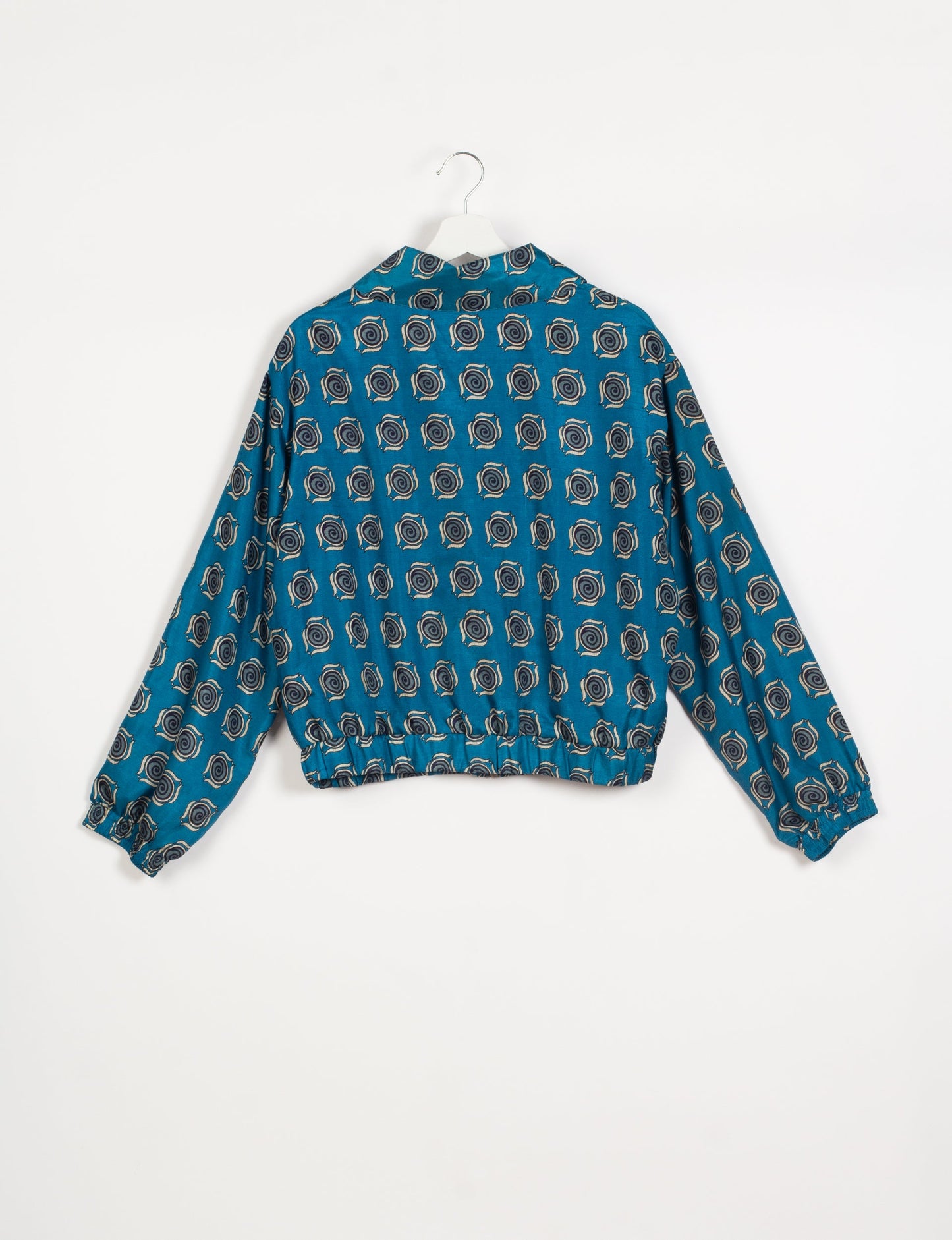 Stylish BOMBER JACKET, an upcycled clothing masterpiece with a cute cropped shape, elasticated details, and detachable metallic zipper. Contrast sari print lining adds a unique touch. Explore sustainable and eco-friendly fashion.