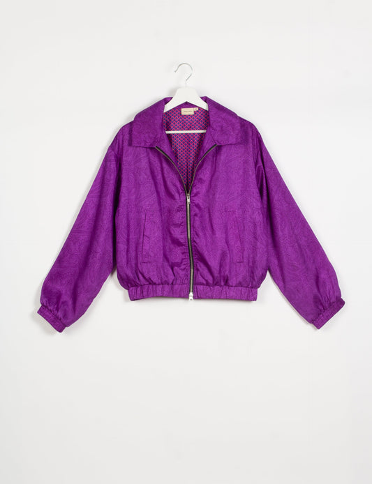 Stylish BOMBER JACKET, an upcycled clothing masterpiece with a cute cropped shape, elasticated details, and detachable metallic zipper. Contrast sari print lining adds a unique touch. Explore sustainable and eco-friendly fashion.