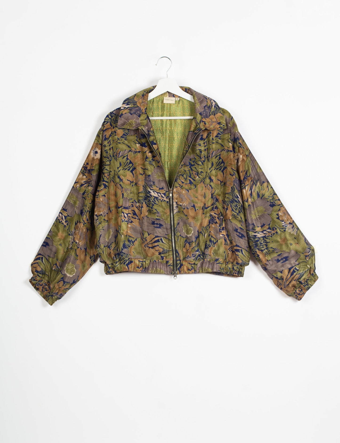 Stylish BOMBER JACKET, an upcycled clothing masterpiece with a cute cropped shape, elasticated details, and detachable metallic zipper. Contrast sari print lining adds a unique touch. Explore sustainable and eco-friendly fashion.