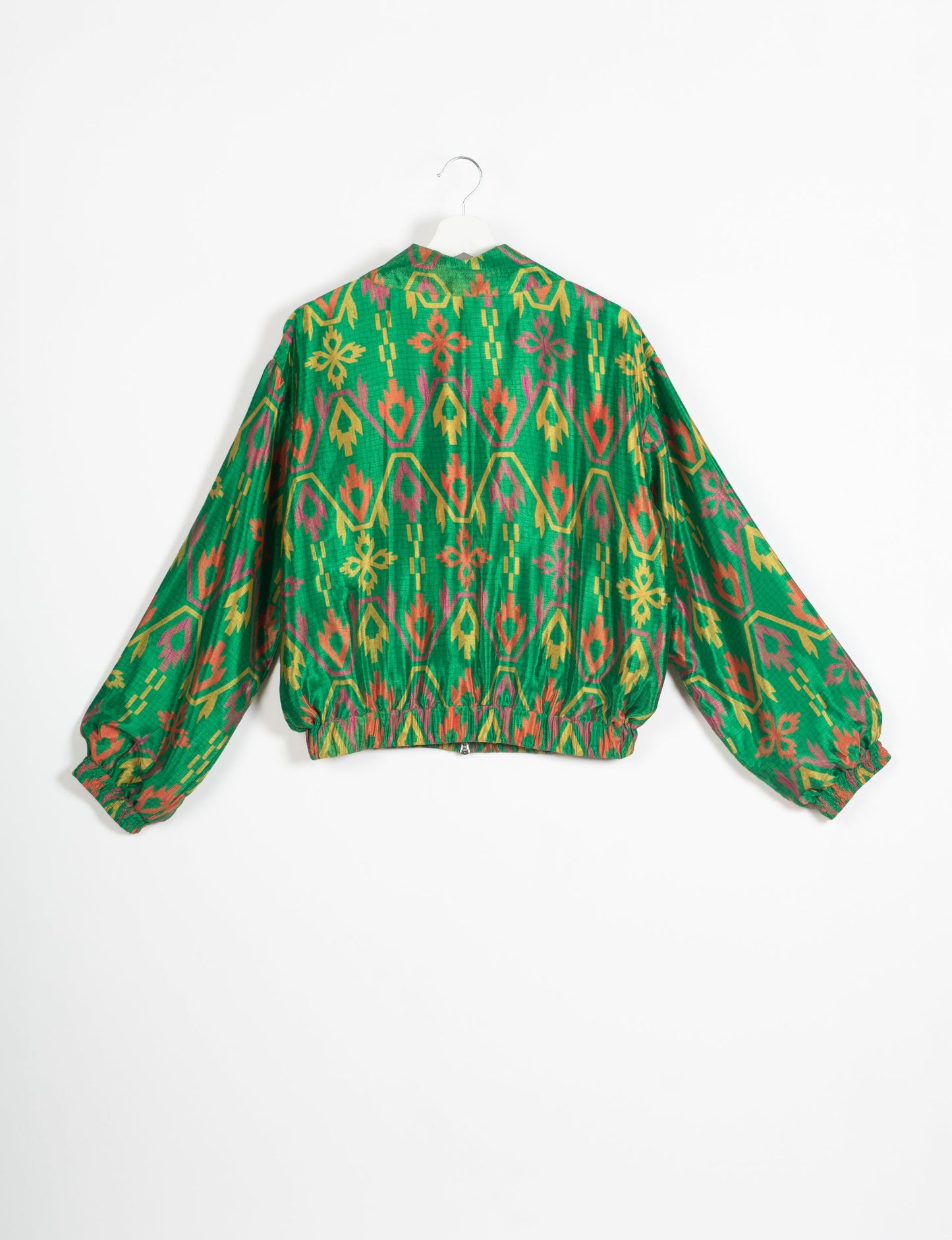 Stylish BOMBER JACKET, an upcycled clothing masterpiece with a cute cropped shape, elasticated details, and detachable metallic zipper. Contrast sari print lining adds a unique touch. Explore sustainable and eco-friendly fashion.