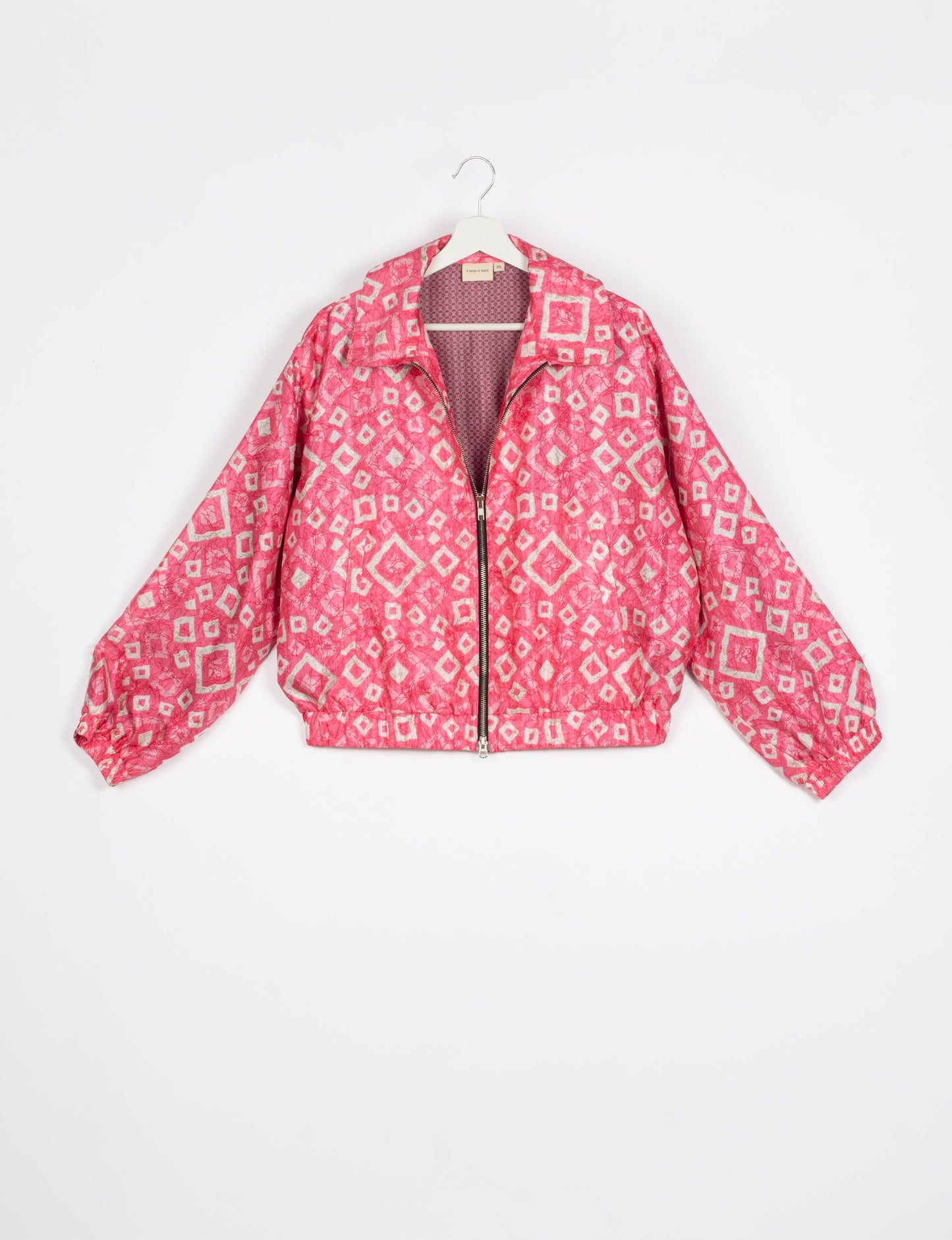 Stylish BOMBER JACKET, an upcycled clothing masterpiece with a cute cropped shape, elasticated details, and detachable metallic zipper. Contrast sari print lining adds a unique touch. Explore sustainable and eco-friendly fashion.