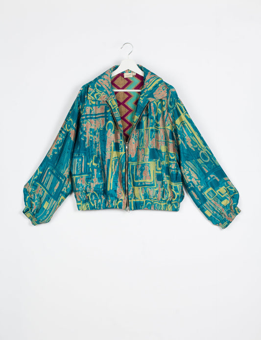 Stylish BOMBER JACKET, an upcycled clothing masterpiece with a cute cropped shape, elasticated details, and detachable metallic zipper. Contrast sari print lining adds a unique touch. Explore sustainable and eco-friendly fashion.