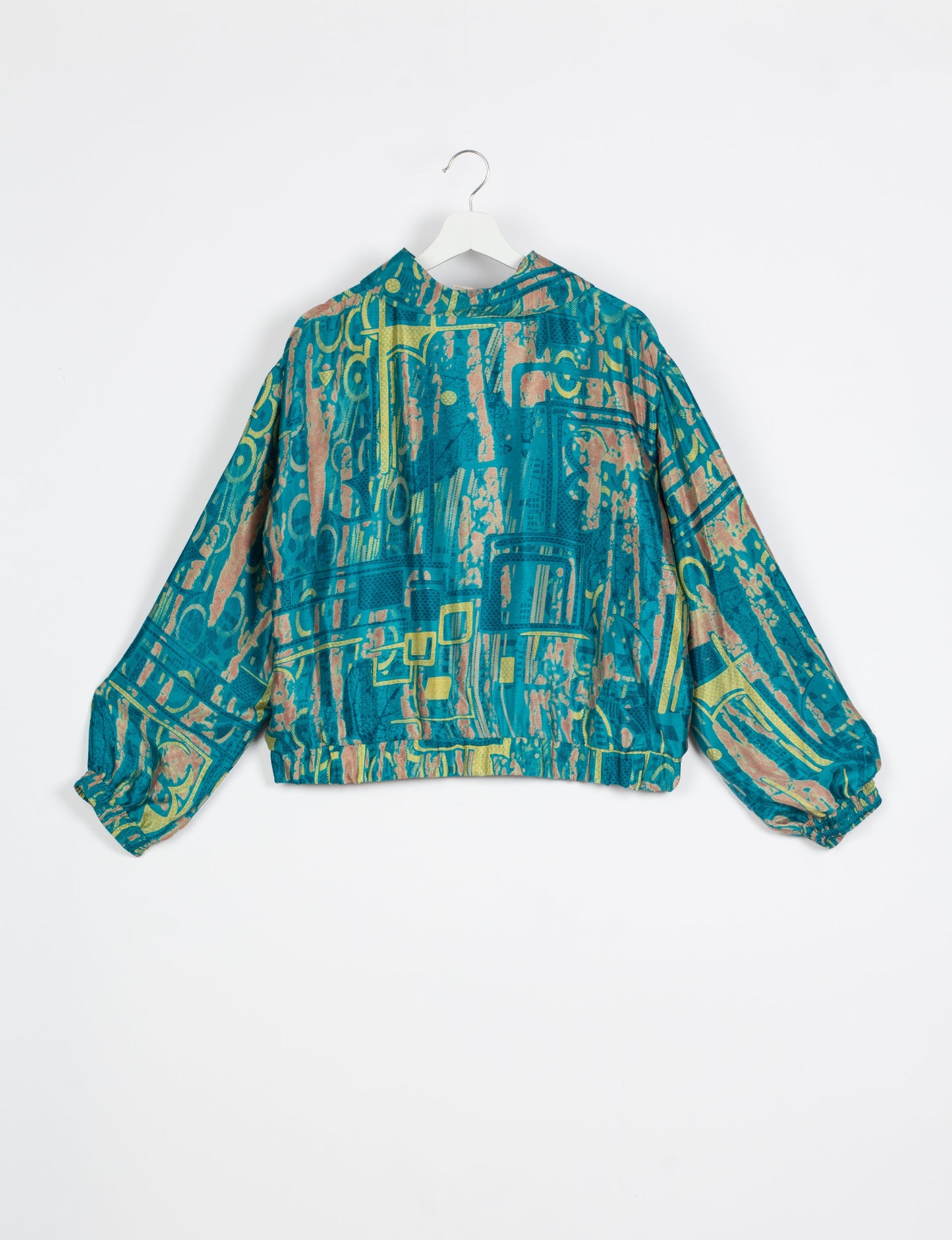 Stylish BOMBER JACKET, an upcycled clothing masterpiece with a cute cropped shape, elasticated details, and detachable metallic zipper. Contrast sari print lining adds a unique touch. Explore sustainable and eco-friendly fashion.