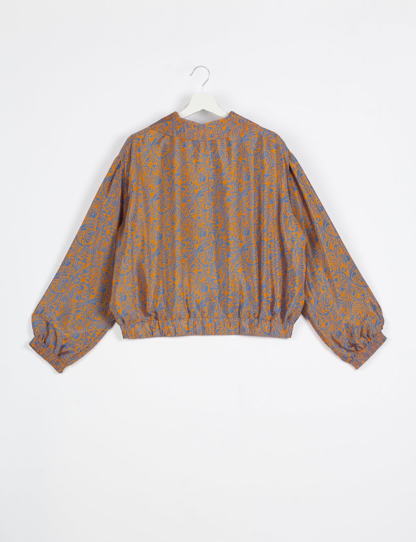 Stylish BOMBER JACKET, an upcycled clothing masterpiece with a cute cropped shape, elasticated details, and detachable metallic zipper. Contrast sari print lining adds a unique touch. Explore sustainable and eco-friendly fashion.