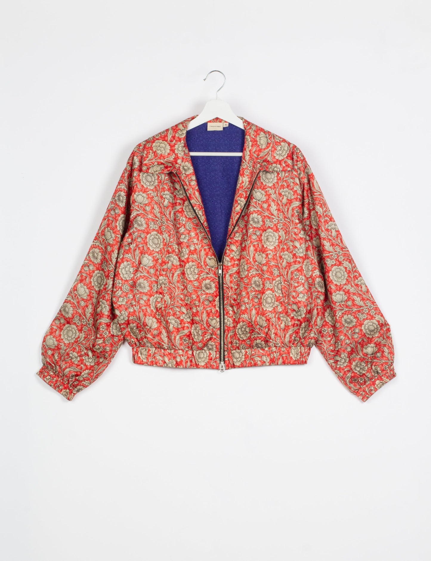 Stylish BOMBER JACKET, an upcycled clothing masterpiece with a cute cropped shape, elasticated details, and detachable metallic zipper. Contrast sari print lining adds a unique touch. Explore sustainable and eco-friendly fashion.