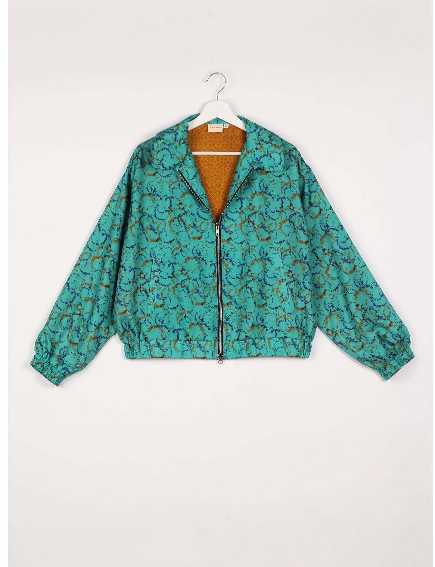 Stylish BOMBER JACKET, an upcycled clothing masterpiece with a cute cropped shape, elasticated details, and detachable metallic zipper. Contrast sari print lining adds a unique touch. Explore sustainable and eco-friendly fashion.