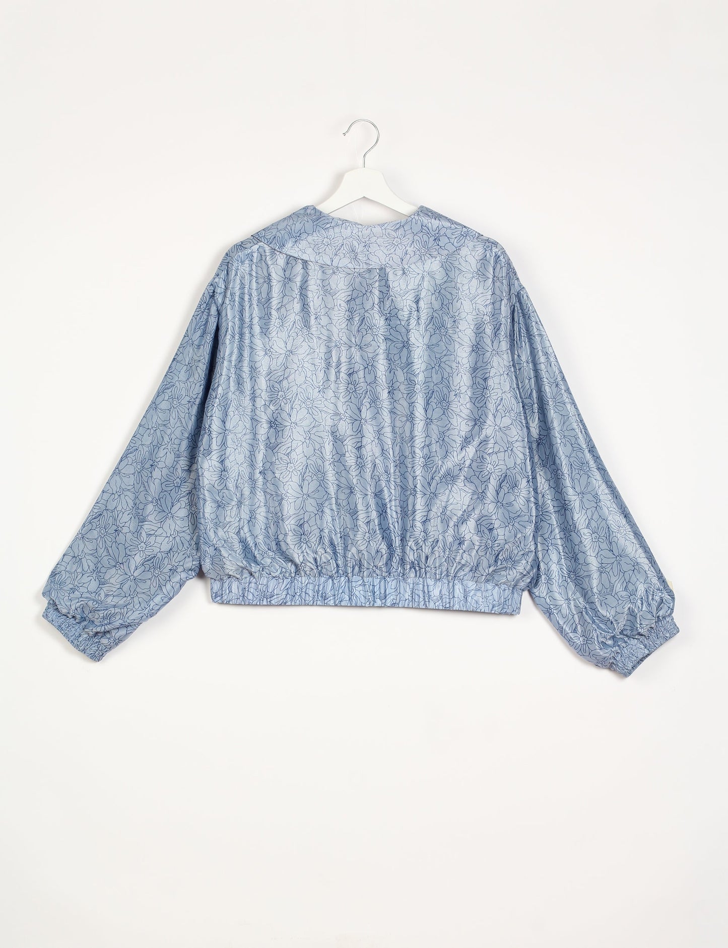 Stylish BOMBER JACKET, an upcycled clothing masterpiece with a cute cropped shape, elasticated details, and detachable metallic zipper. Contrast sari print lining adds a unique touch. Explore sustainable and eco-friendly fashion.