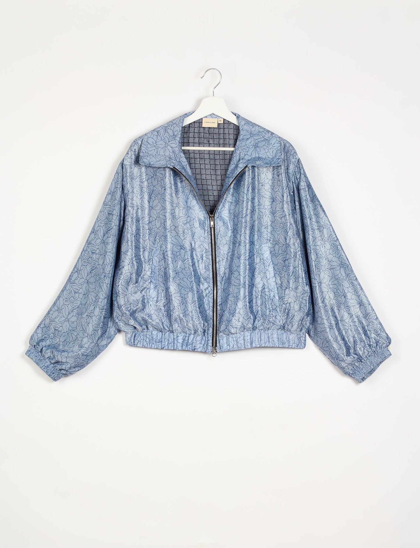 Stylish BOMBER JACKET, an upcycled clothing masterpiece with a cute cropped shape, elasticated details, and detachable metallic zipper. Contrast sari print lining adds a unique touch. Explore sustainable and eco-friendly fashion.