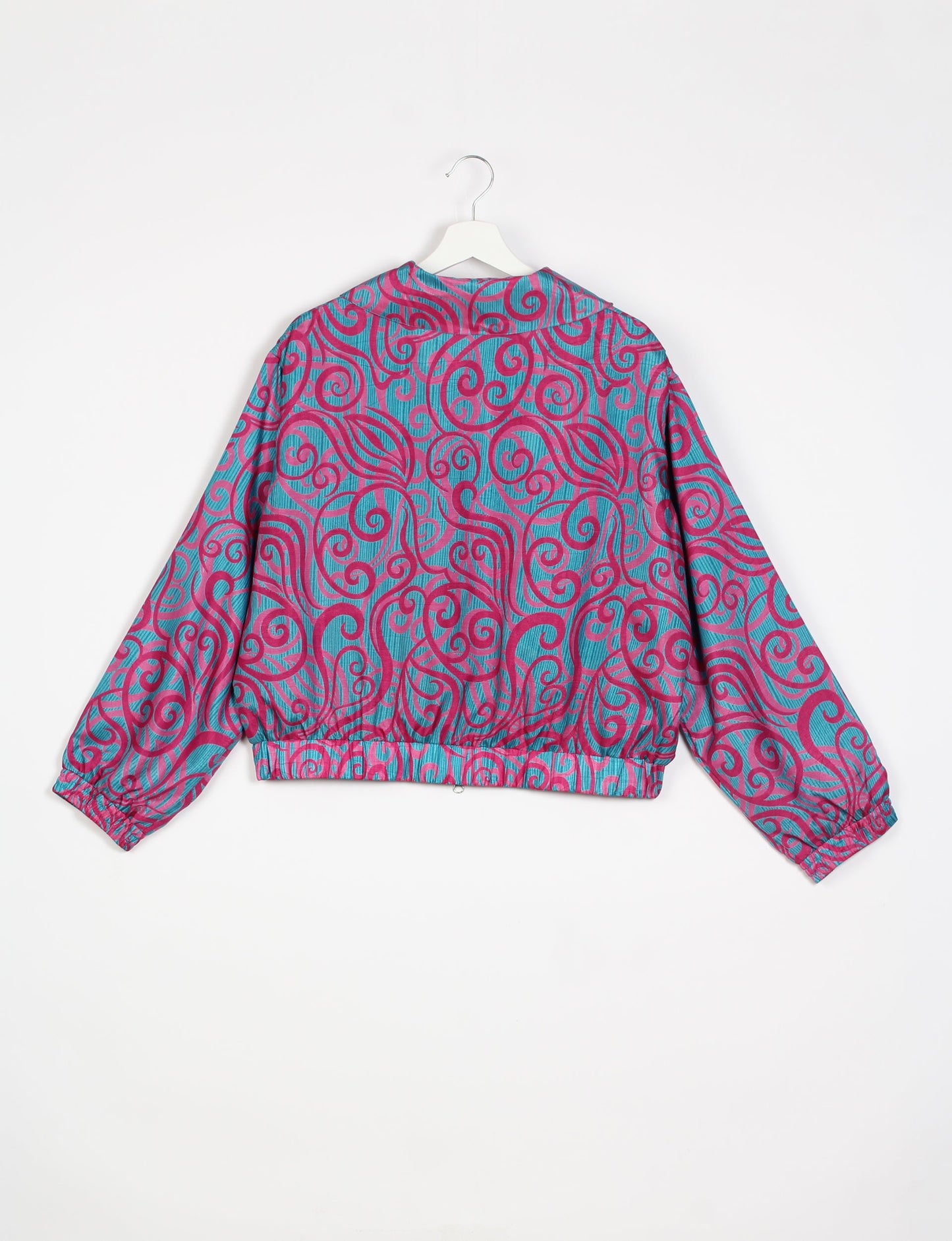 Stylish BOMBER JACKET, an upcycled clothing masterpiece with a cute cropped shape, elasticated details, and detachable metallic zipper. Contrast sari print lining adds a unique touch. Explore sustainable and eco-friendly fashion.