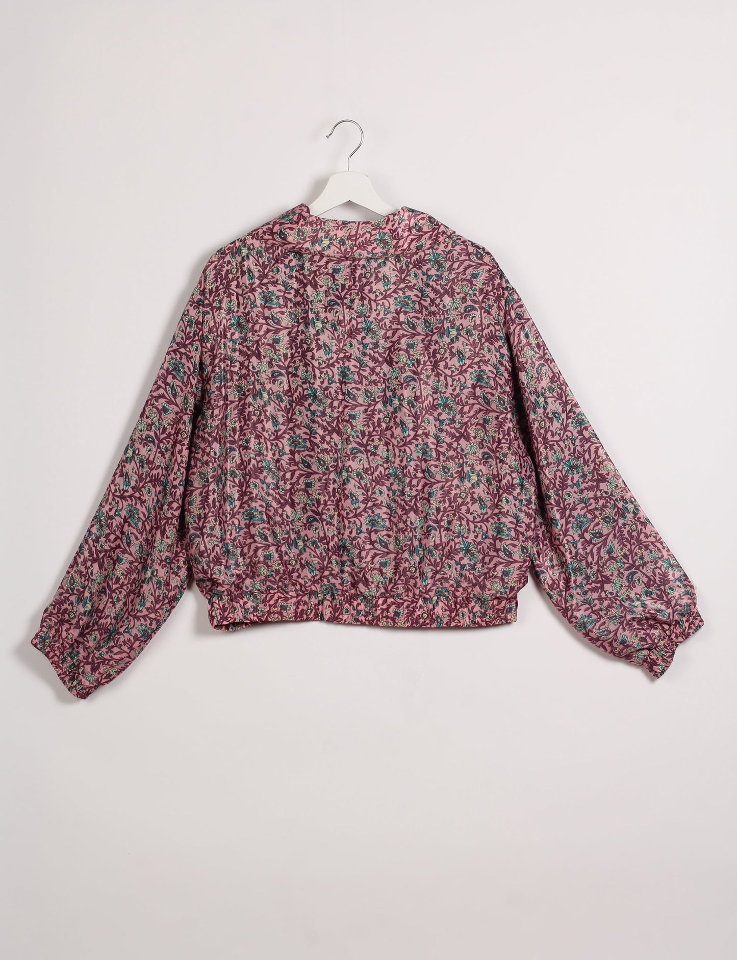 Stylish BOMBER JACKET, an upcycled clothing masterpiece with a cute cropped shape, elasticated details, and detachable metallic zipper. Contrast sari print lining adds a unique touch. Explore sustainable and eco-friendly fashion.