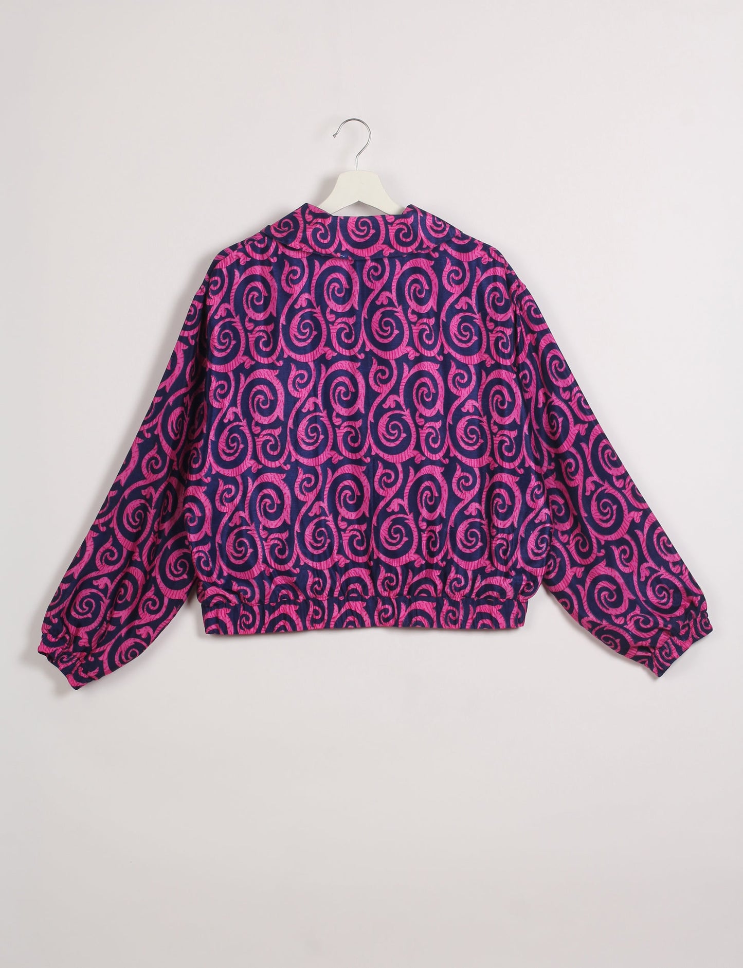 Stylish BOMBER JACKET, an upcycled clothing masterpiece with a cute cropped shape, elasticated details, and detachable metallic zipper. Contrast sari print lining adds a unique touch. Explore sustainable and eco-friendly fashion.