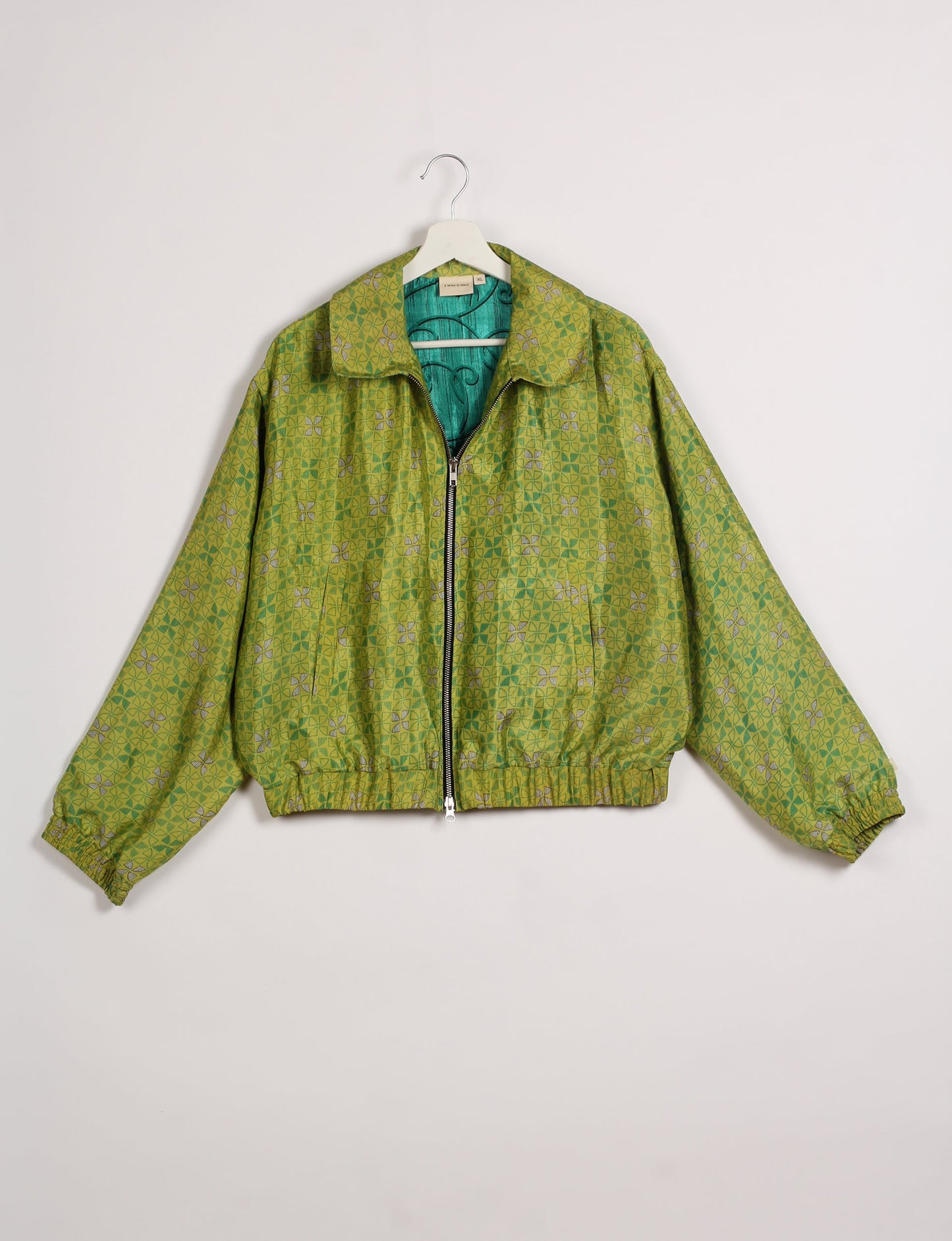 Stylish BOMBER JACKET, an upcycled clothing masterpiece with a cute cropped shape, elasticated details, and detachable metallic zipper. Contrast sari print lining adds a unique touch. Explore sustainable and eco-friendly fashion.