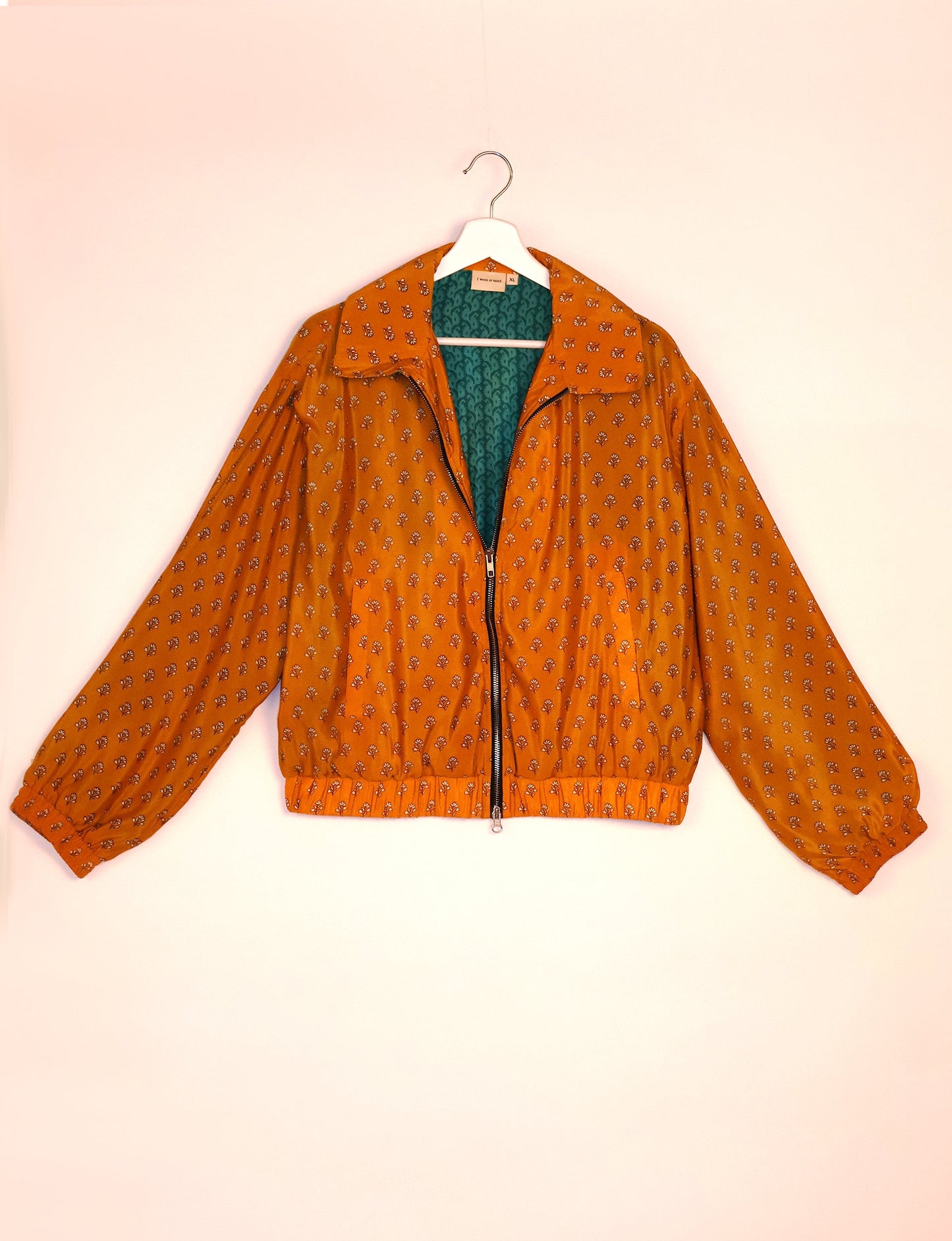 Stylish BOMBER JACKET, an upcycled clothing masterpiece with a cute cropped shape, elasticated details, and detachable metallic zipper. Contrast sari print lining adds a unique touch. Explore sustainable and eco-friendly fashion.