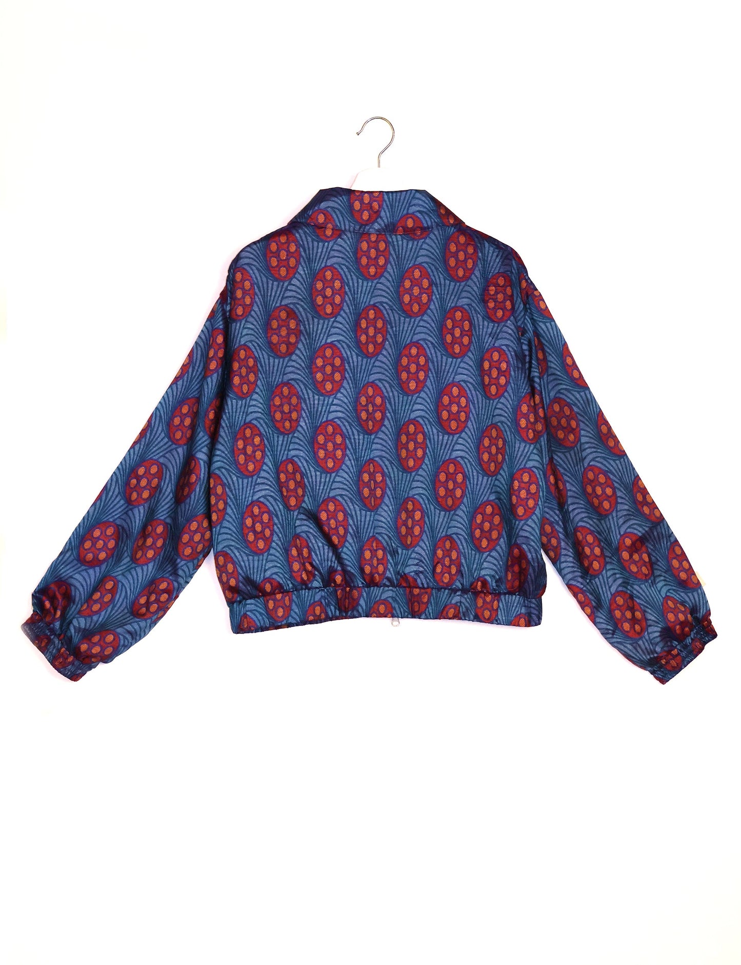 Stylish BOMBER JACKET, an upcycled clothing masterpiece with a cute cropped shape, elasticated details, and detachable metallic zipper. Contrast sari print lining adds a unique touch. Explore sustainable and eco-friendly fashion.