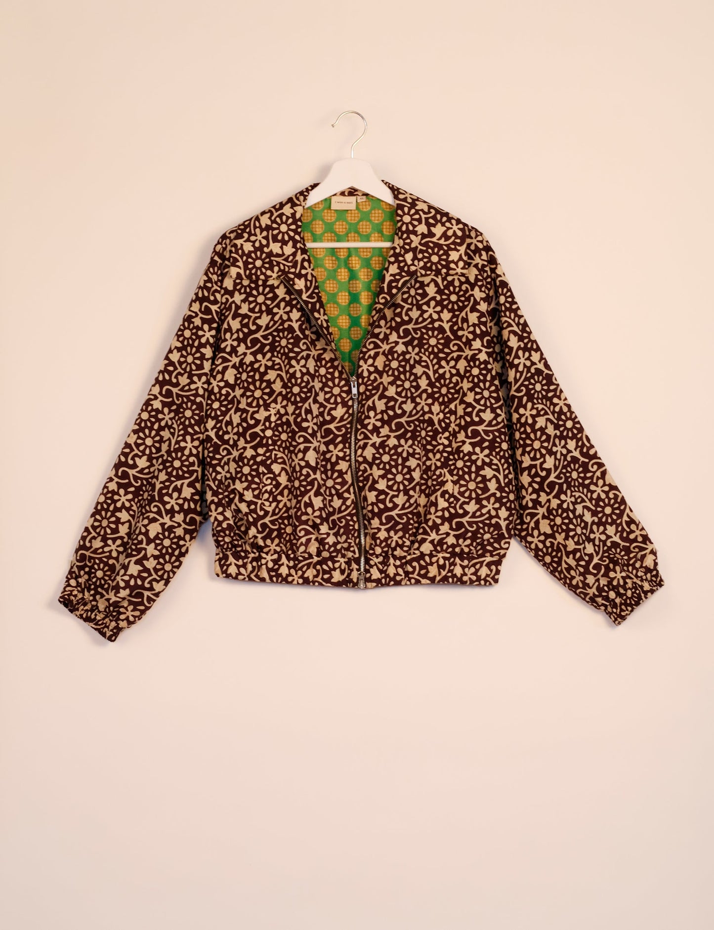 Stylish BOMBER JACKET, an upcycled clothing masterpiece with a cute cropped shape, elasticated details, and detachable metallic zipper. Contrast sari print lining adds a unique touch. Explore sustainable and eco-friendly fashion.