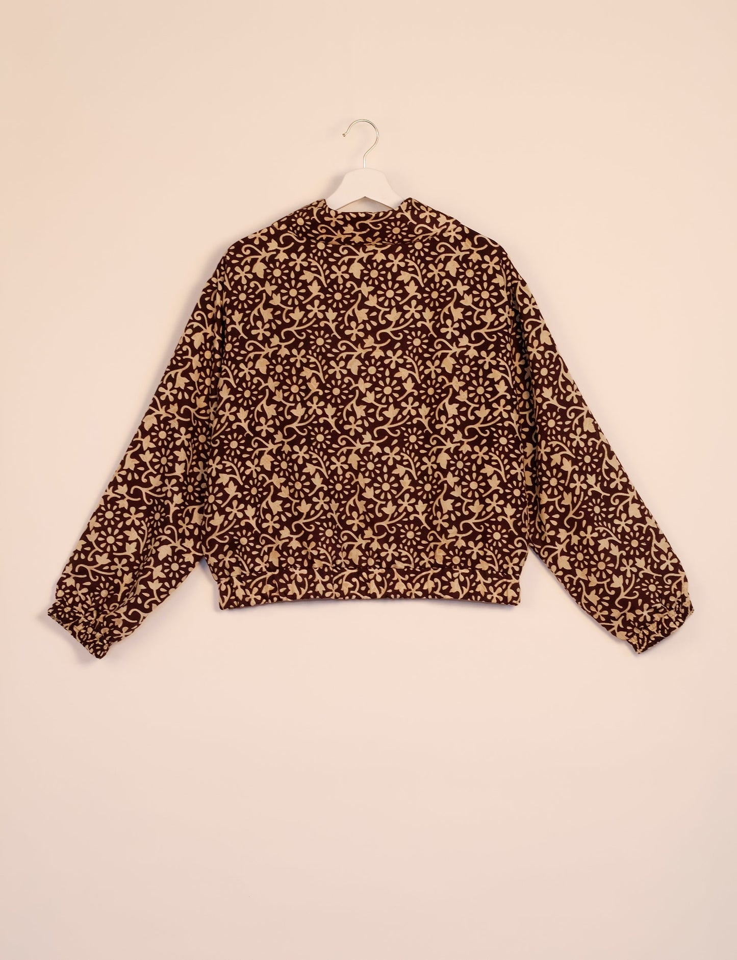 Stylish BOMBER JACKET, an upcycled clothing masterpiece with a cute cropped shape, elasticated details, and detachable metallic zipper. Contrast sari print lining adds a unique touch. Explore sustainable and eco-friendly fashion.